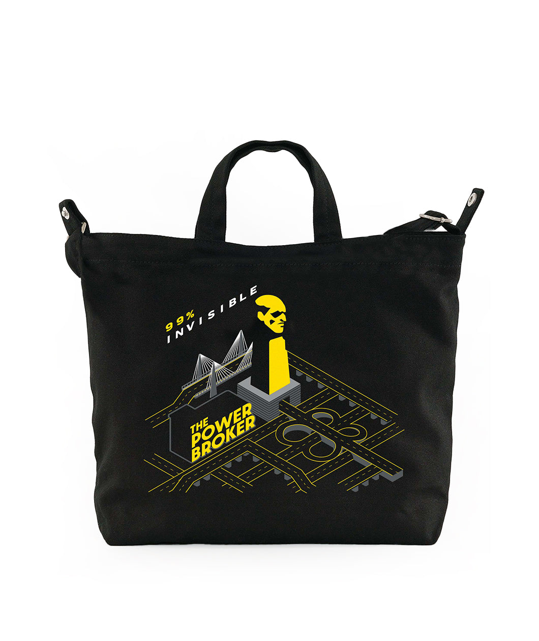 Black tote bag featuring graphic design elements including the text '99% INVISIBLE' and 'THE POWER BROKER,' along with an illustrated figure and abstract cityscape.