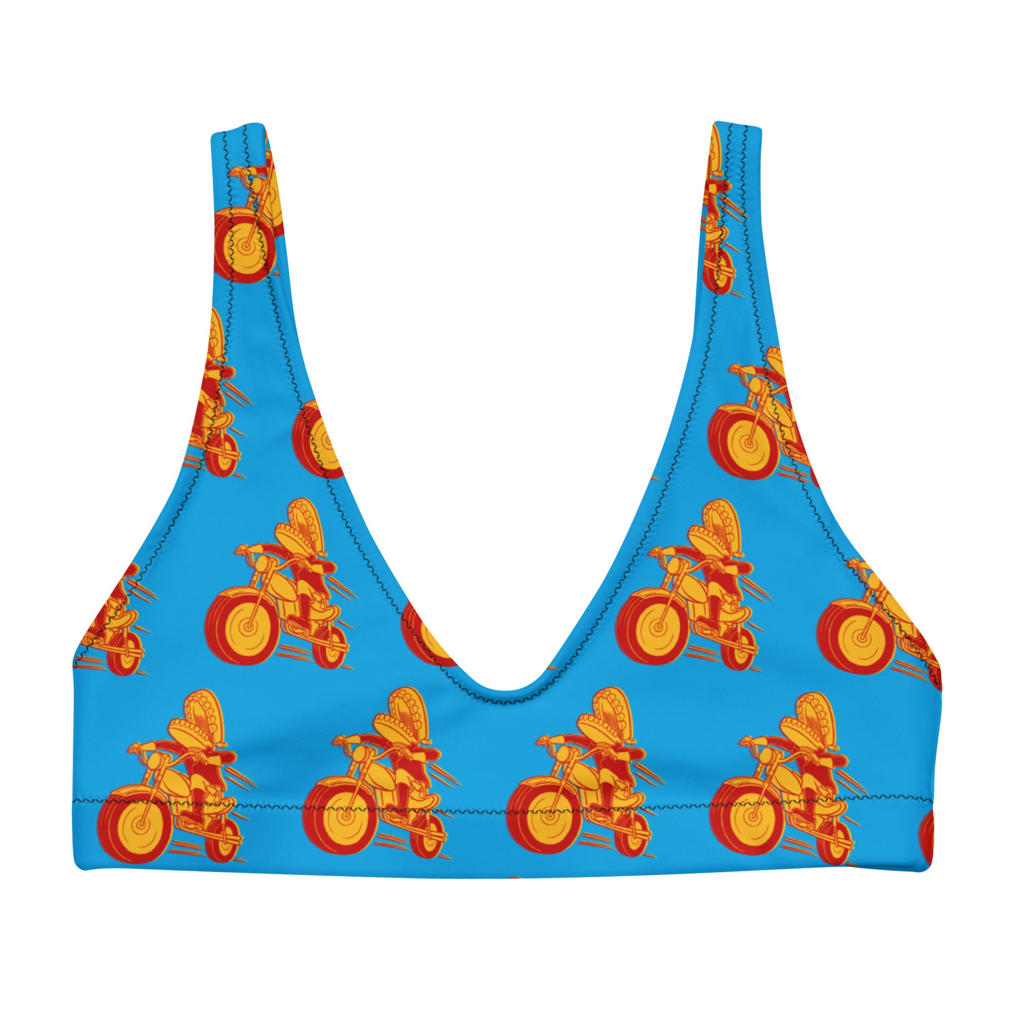 A blue bikini top laid flat, showing a scoop neckline and wide straps, with a repeated red and yellow pattern of Comedy Bang Bang's classic mascot Motormouth character who has chattering teeth for a head and rides a motorcycle in the graphic.
