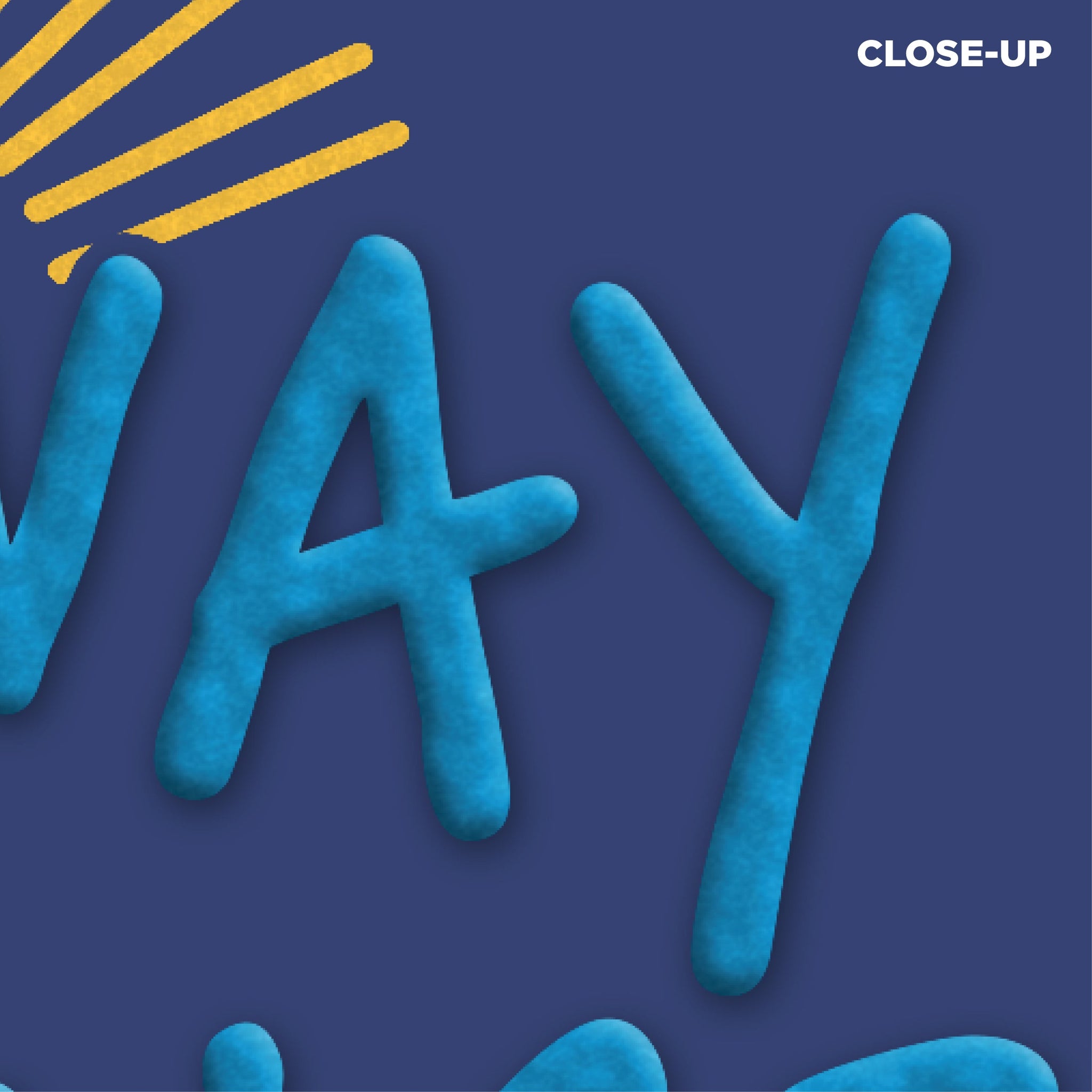 A close-up of the hoodie fabric and design, showing the textured, raised blue lettering of the word 'WAY' from 'HIGHWAY' against the soft, dark blue sweatshirt fabric, with yellow sunburst lines visible in the top corner and the word 'CLOSE-UP' labeled in white text.