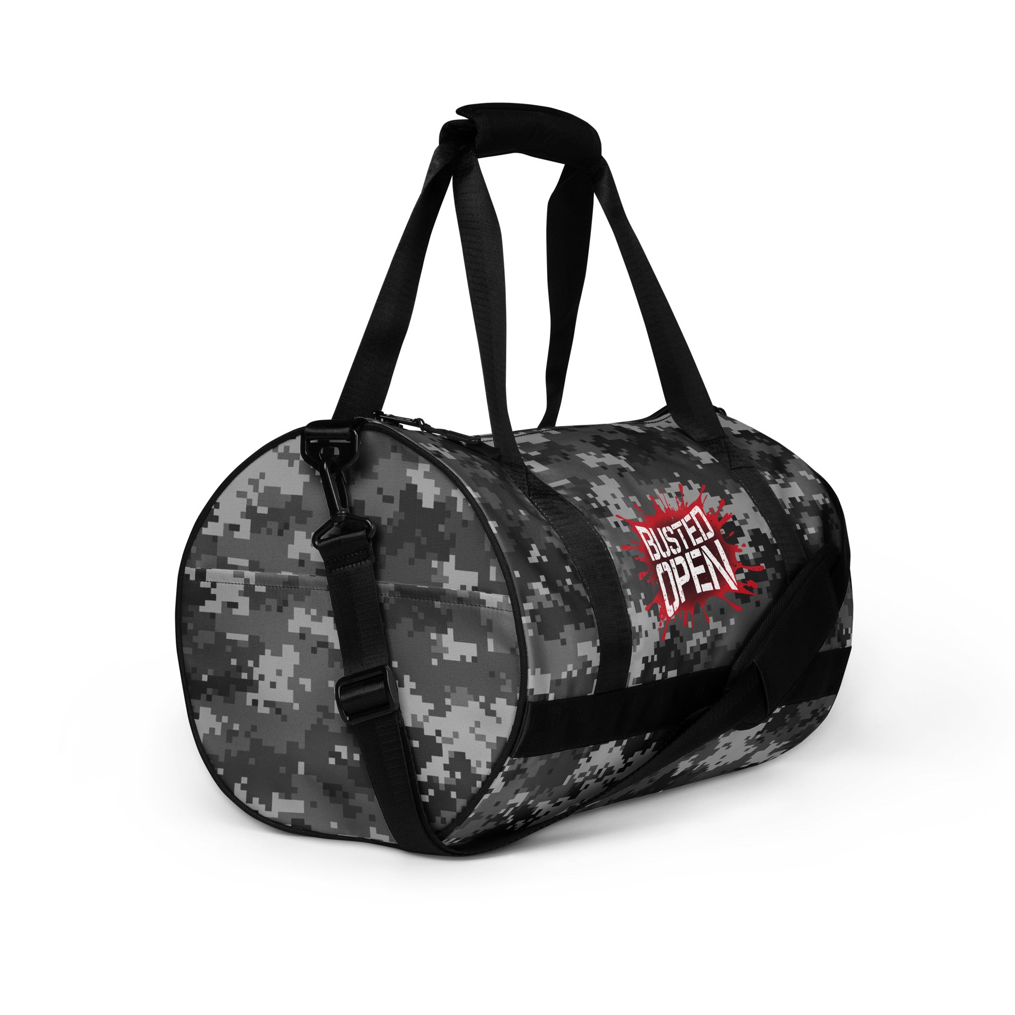 A round camo duffel bag with red 'BUSTED OPEN' text on the side, featuring black straps.