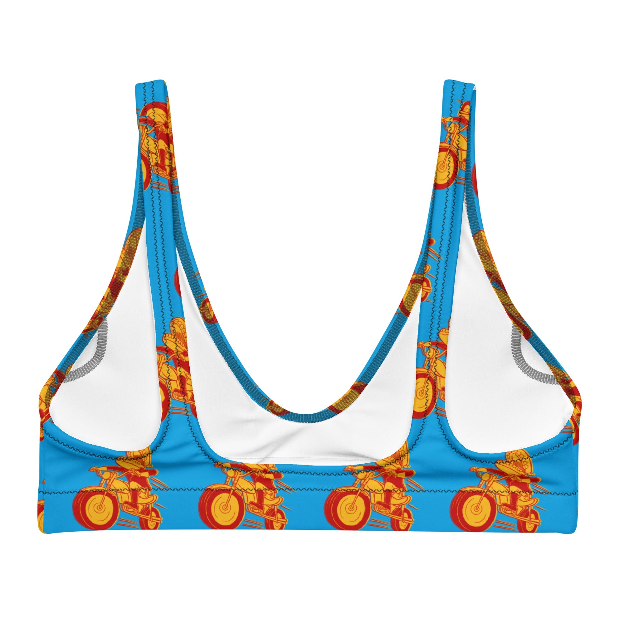 A blue bikini top with a scoop back and wide straps, shown flat with a repeating print of the red and yellow Motormouth cartoon motorcycle character on a bright blue background. The white lining is visible inside the cups.