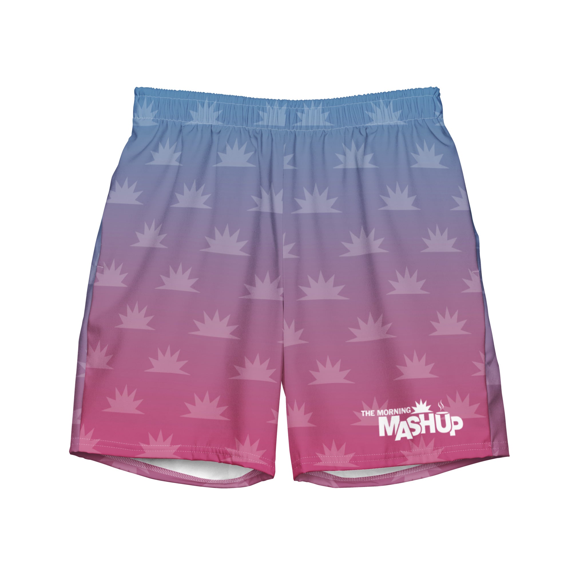 Men's swim trunks with a gradient blue to pink color scheme and a pattern of white crown-like shapes, featuring 'THE MORNING MASHUP' logo on the bottom right.