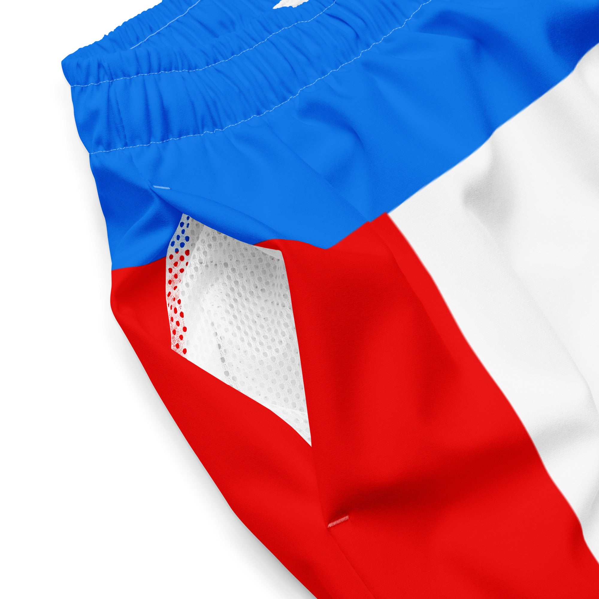A zoomed-in detail of the side of the swim trunks, showing the mesh-lined interior of the pocket and red, white, and blue exterior panel design.