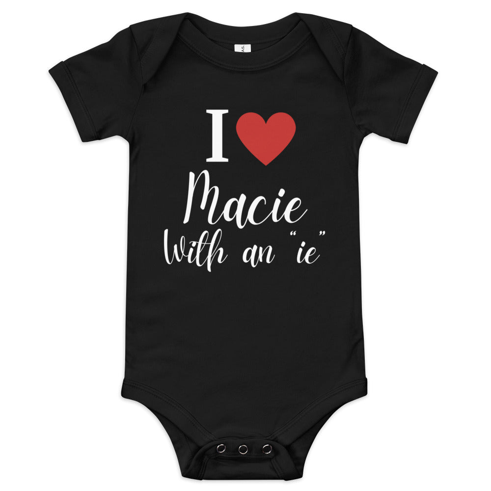 Black baby onesie with the text 'I love Macie with an 'ie' in playful script featuring red heart.
