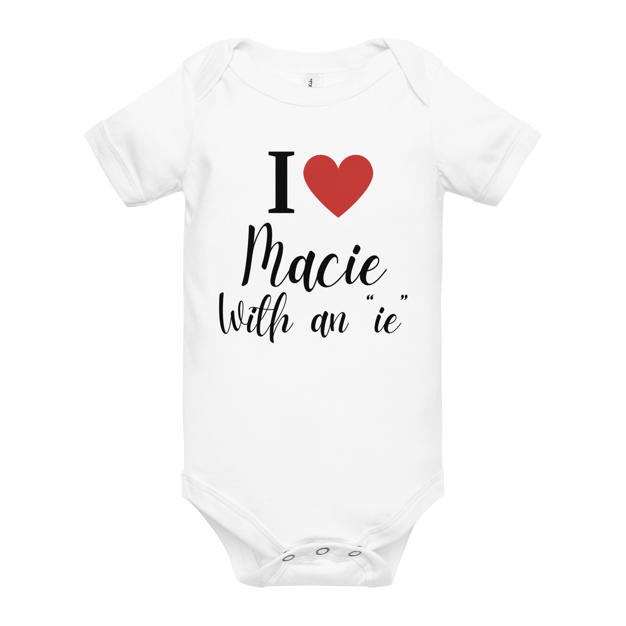 White baby onesie with the text 'I love Macie with an 'ie' in playful script featuring red heart.