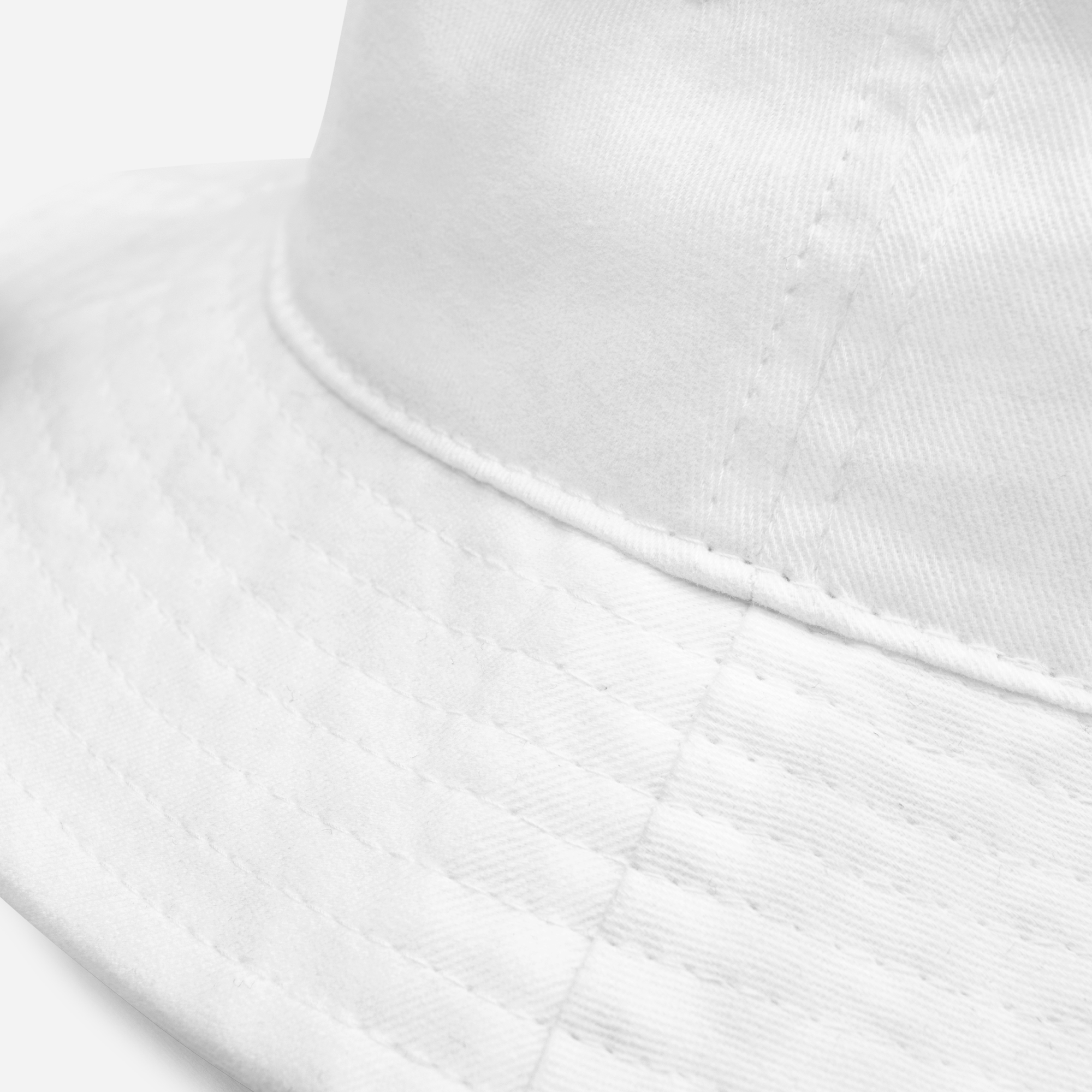 Close-up of a white bucket hat showcasing the fabric texture and stitching details.