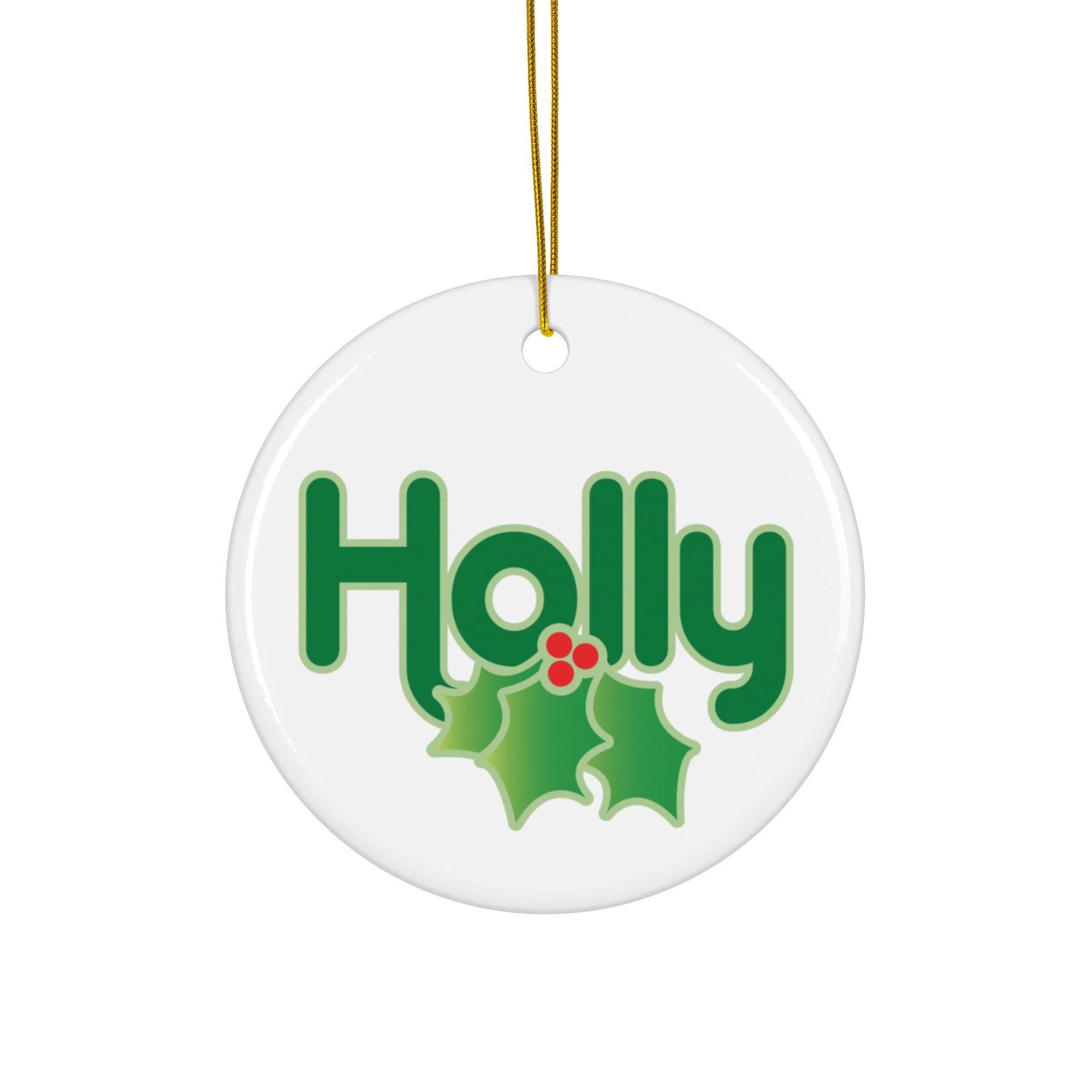 White round ceramic ornament with a gold string, displaying the word ‘Holly’ in bright green lettering paired with green holly leaves and red berries below the text.