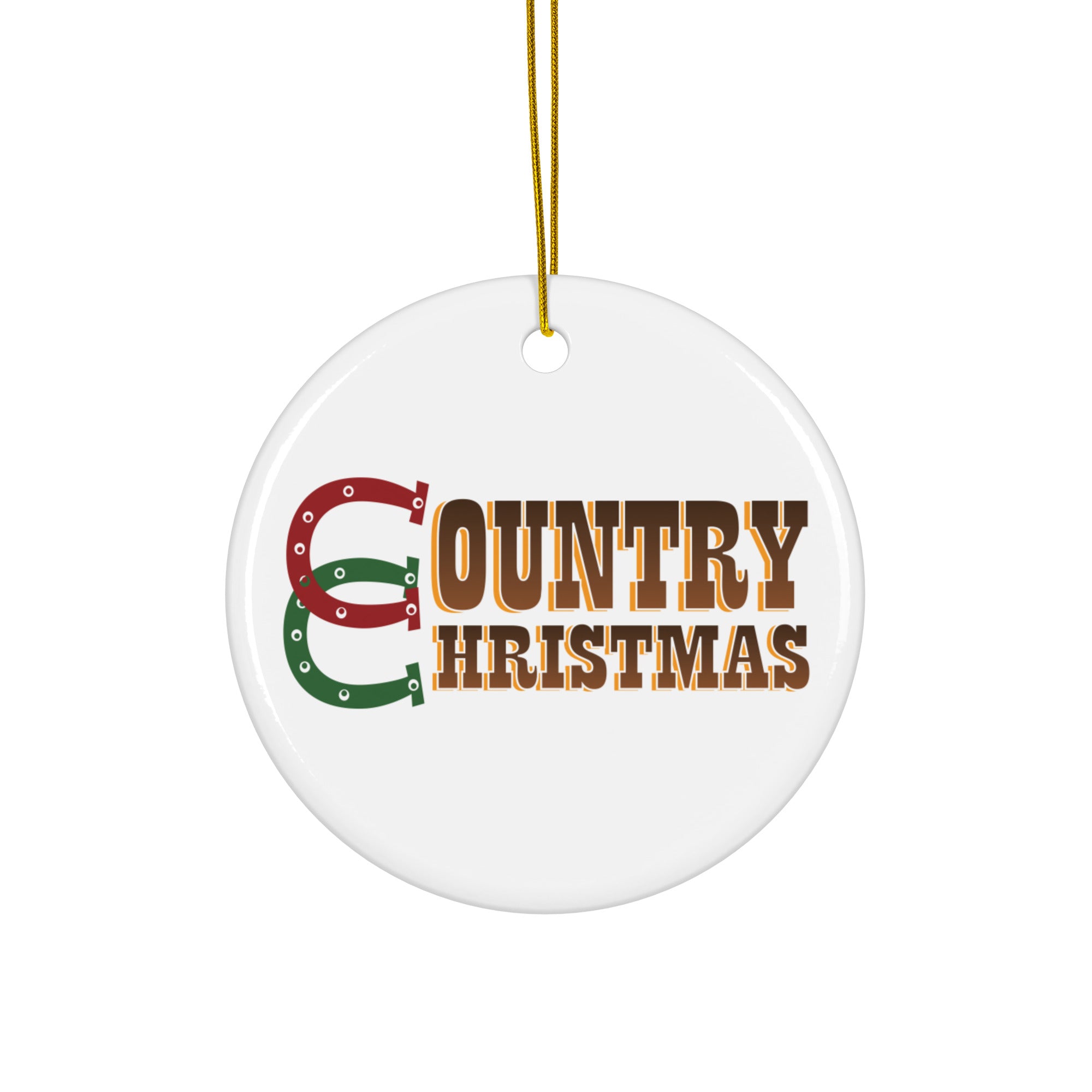 White round ceramic ornament with a gold hanging string, featuring the words ‘COUNTRY CHRISTMAS’ in bold brown letters with red and green horseshoes forming the letter ‘C’.