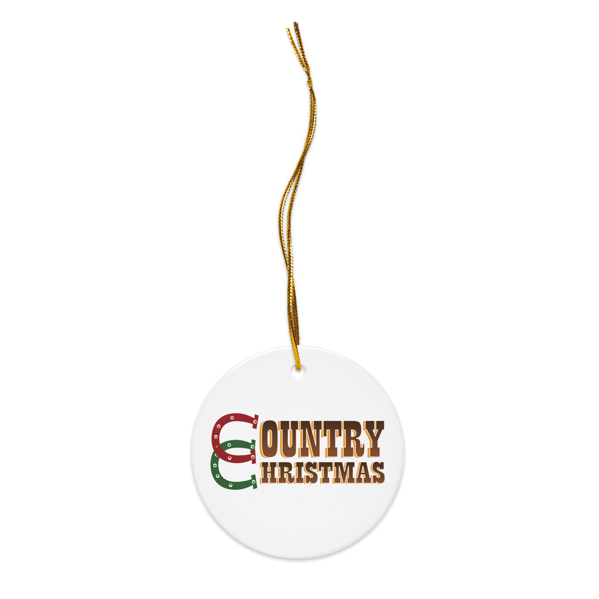 White round ceramic ornament shown with a gold hanging string, featuring the words ‘COUNTRY CHRISTMAS’ in brown block lettering with red and green horseshoes making up the letter ‘C’.