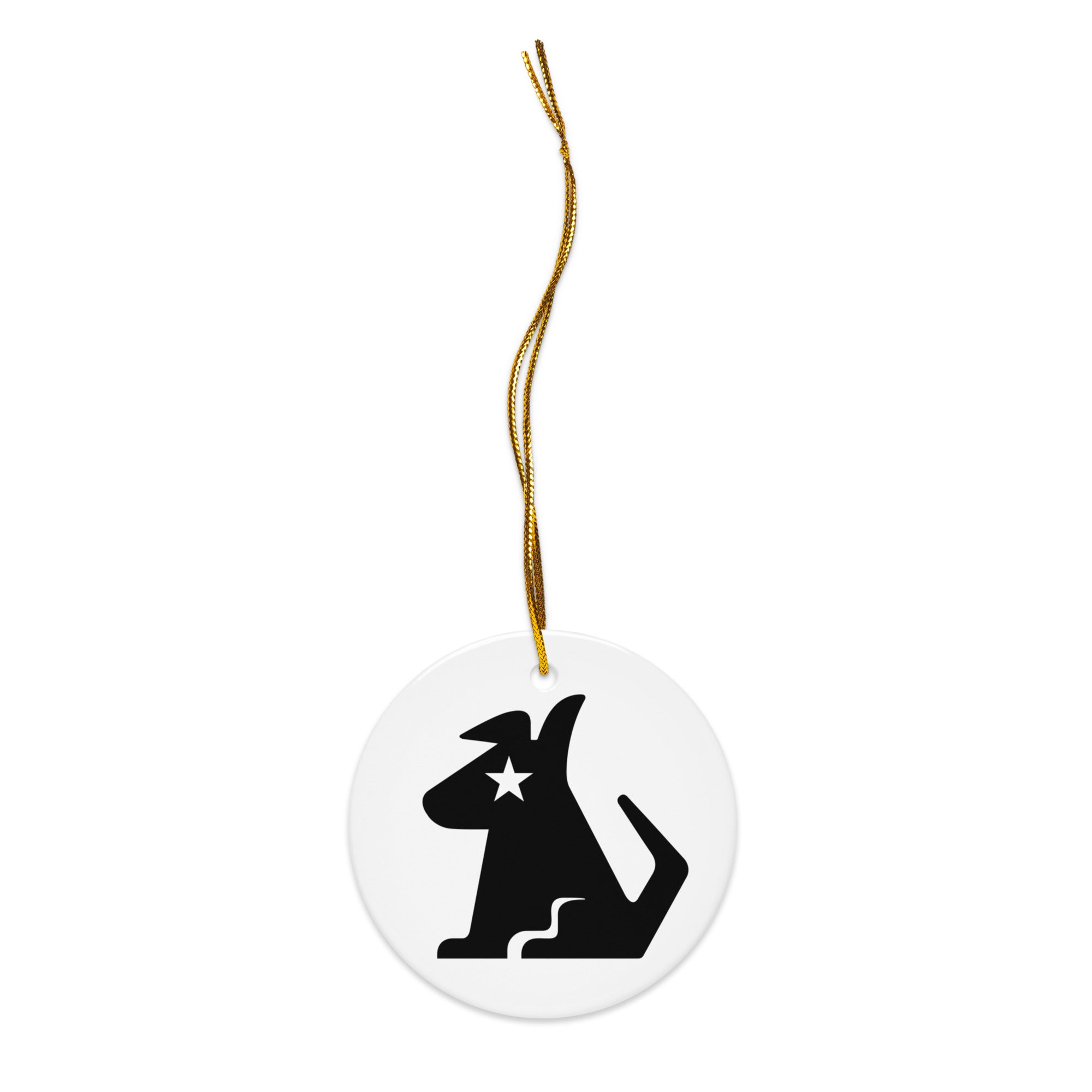 Close-up of a white round ornament with a gold hanging string, decorated with the black Stella Dog logo, featuring the iconic star detail on her face.