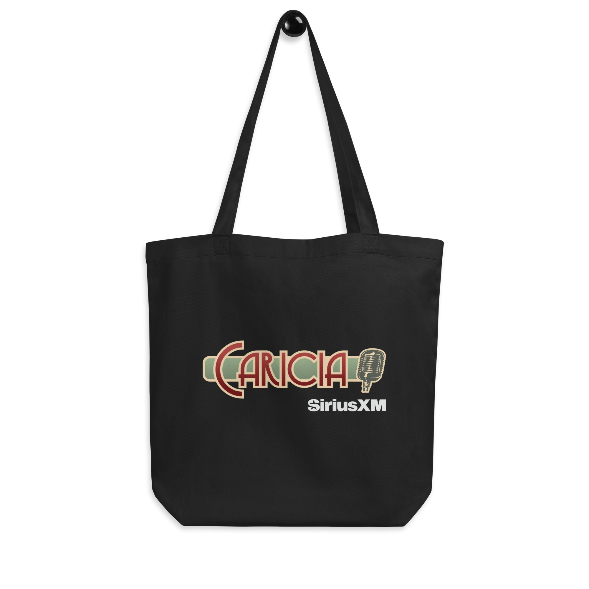 Black tote bag featuring 'CARICIA' text in ruby and green and SiriusXM logo in white.