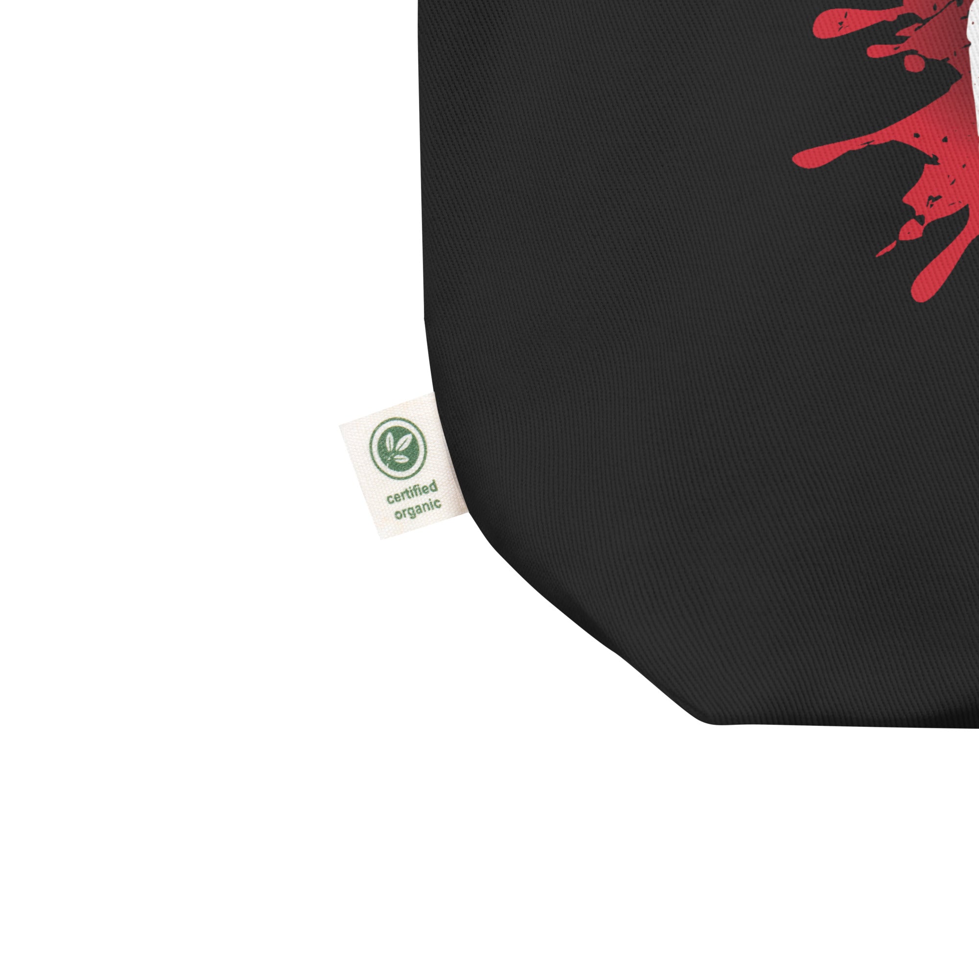 Close up of black bag with red splatter design and a 'certified organic' tag.