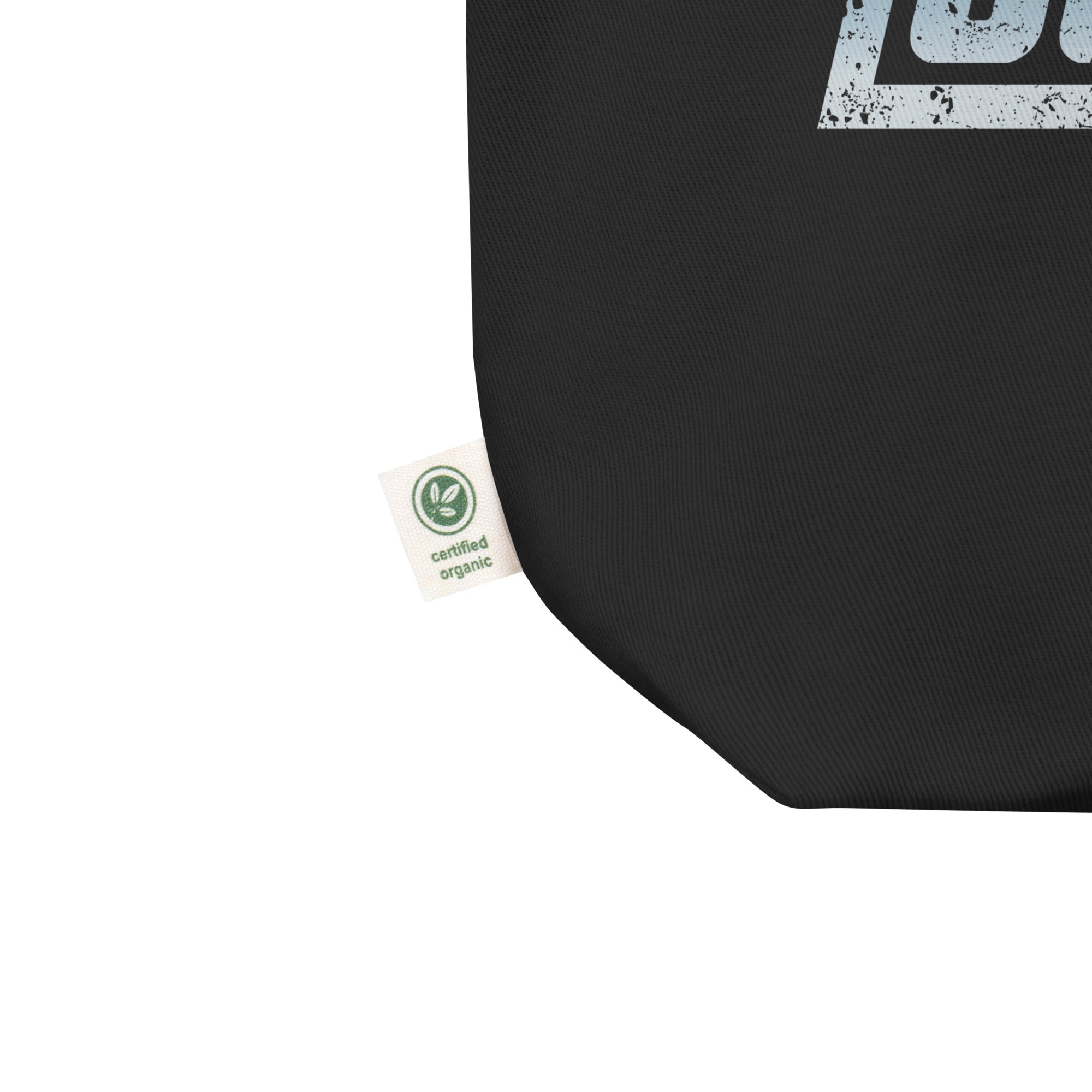 Close up of black tote bag corner with a small label stating 'certified organic.'