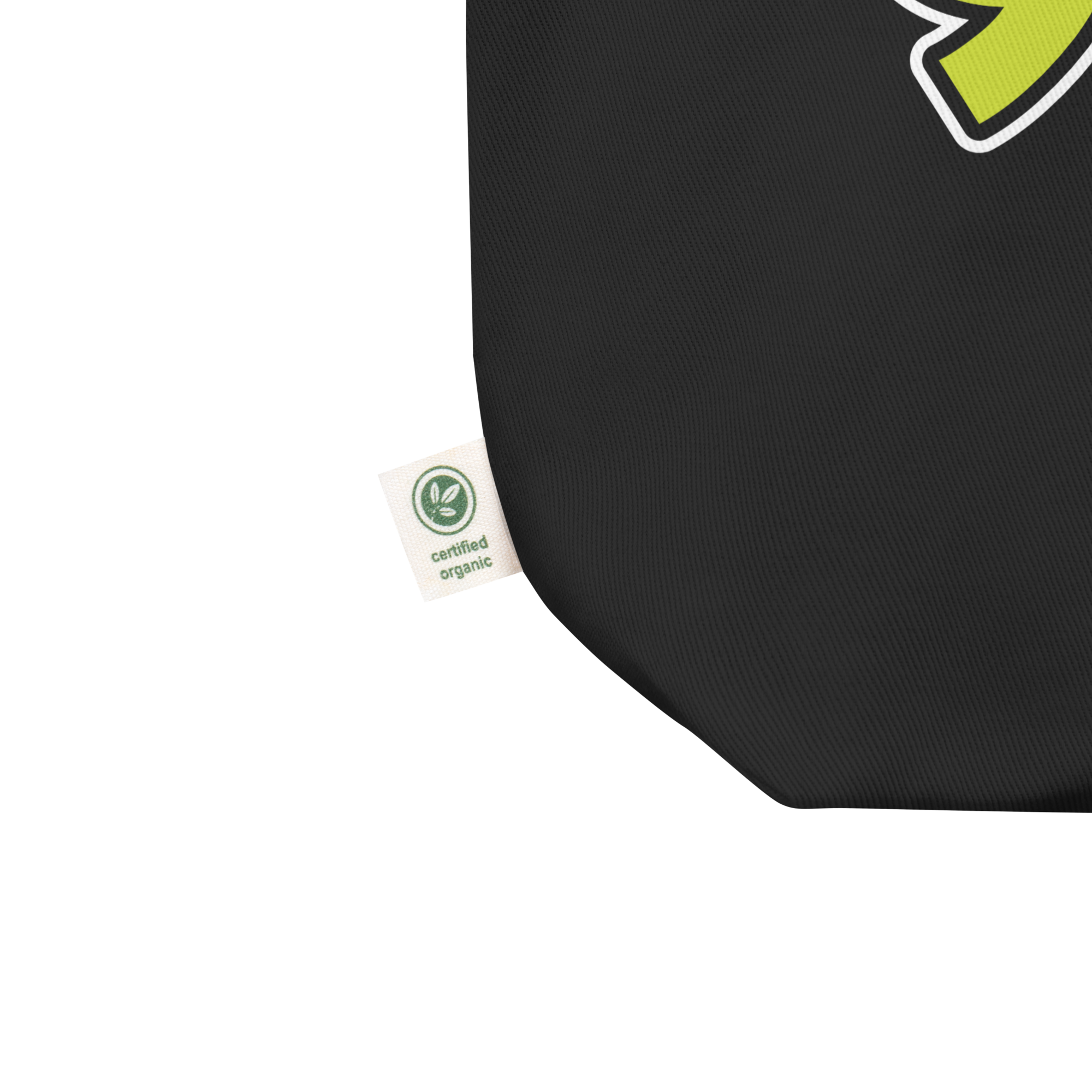 Close up od black tote bag corner featuring a white tag labeled 'certified organic.'