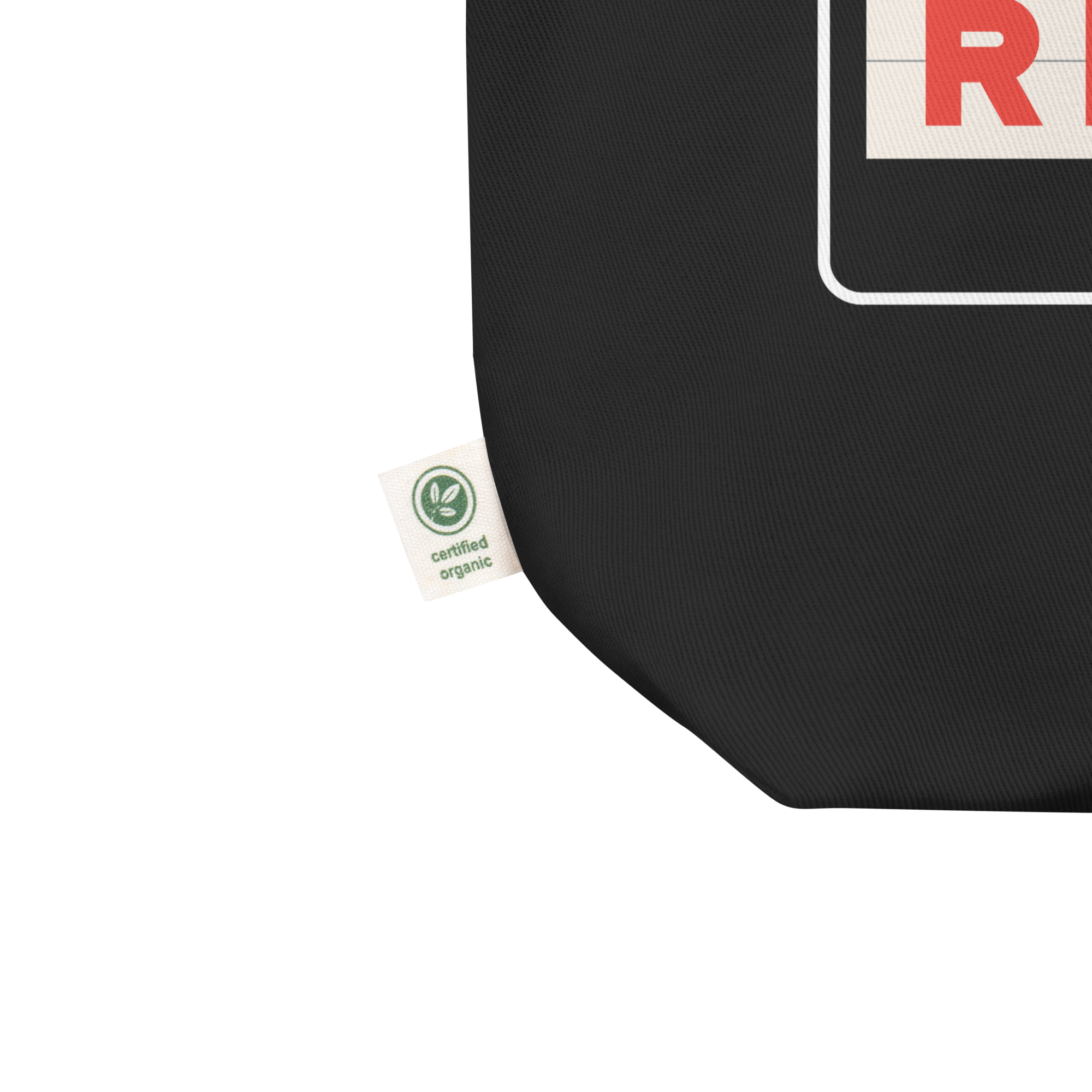 Close up of black tote bag corner with a  'certified organic' tag.