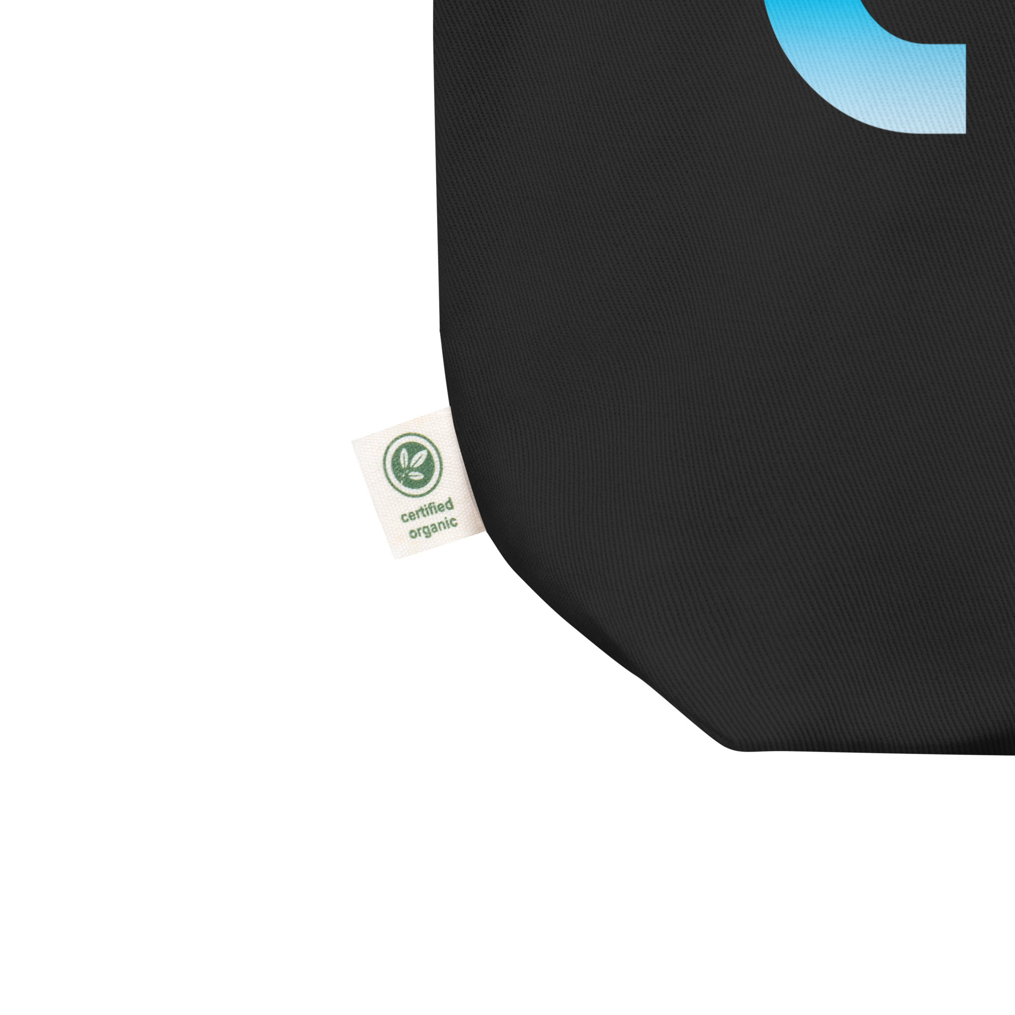 Close up of black tote bag with a small label stating 'certified organic' on the tag.