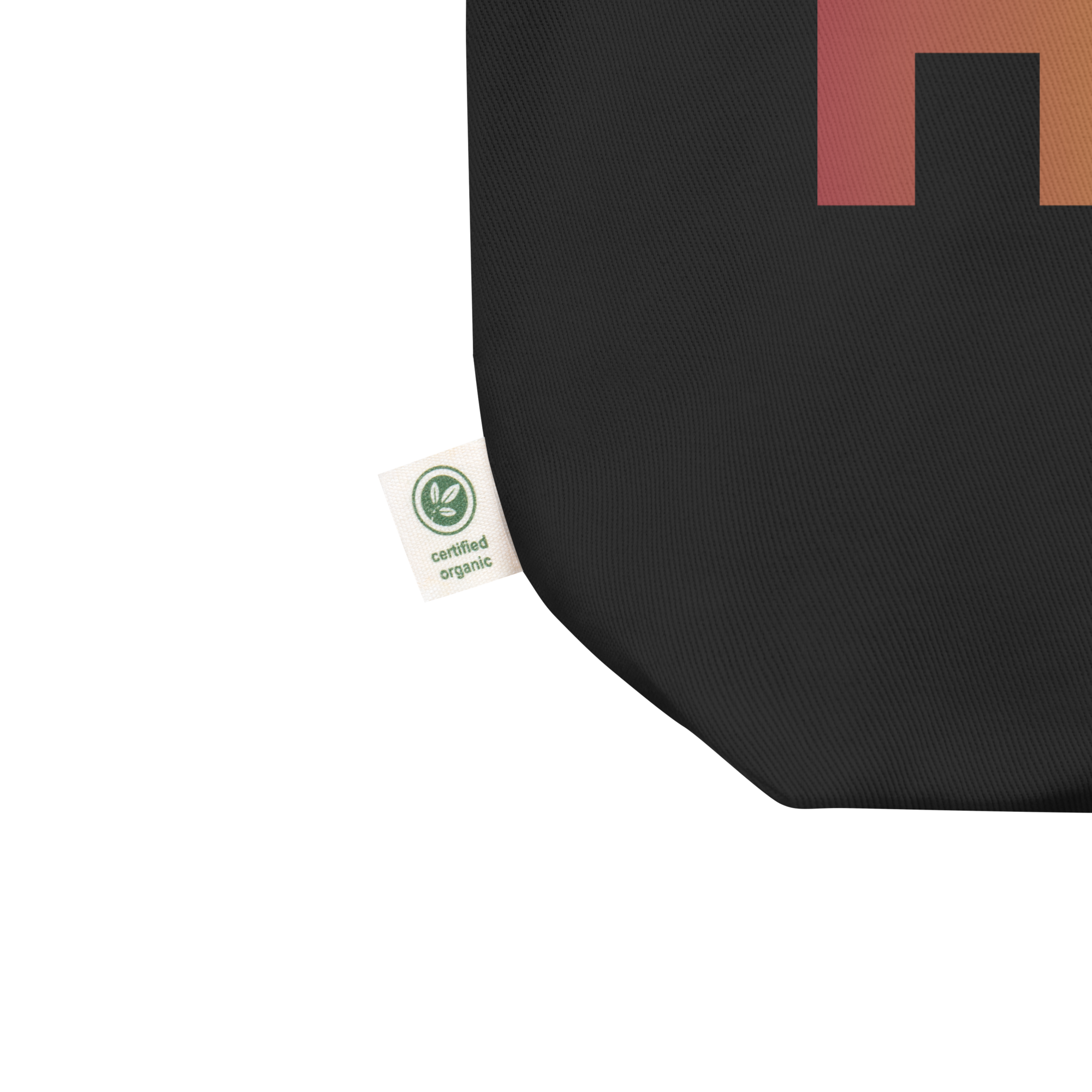 Close up of black tote bag with a small 'certified organic' label visible at the corner.