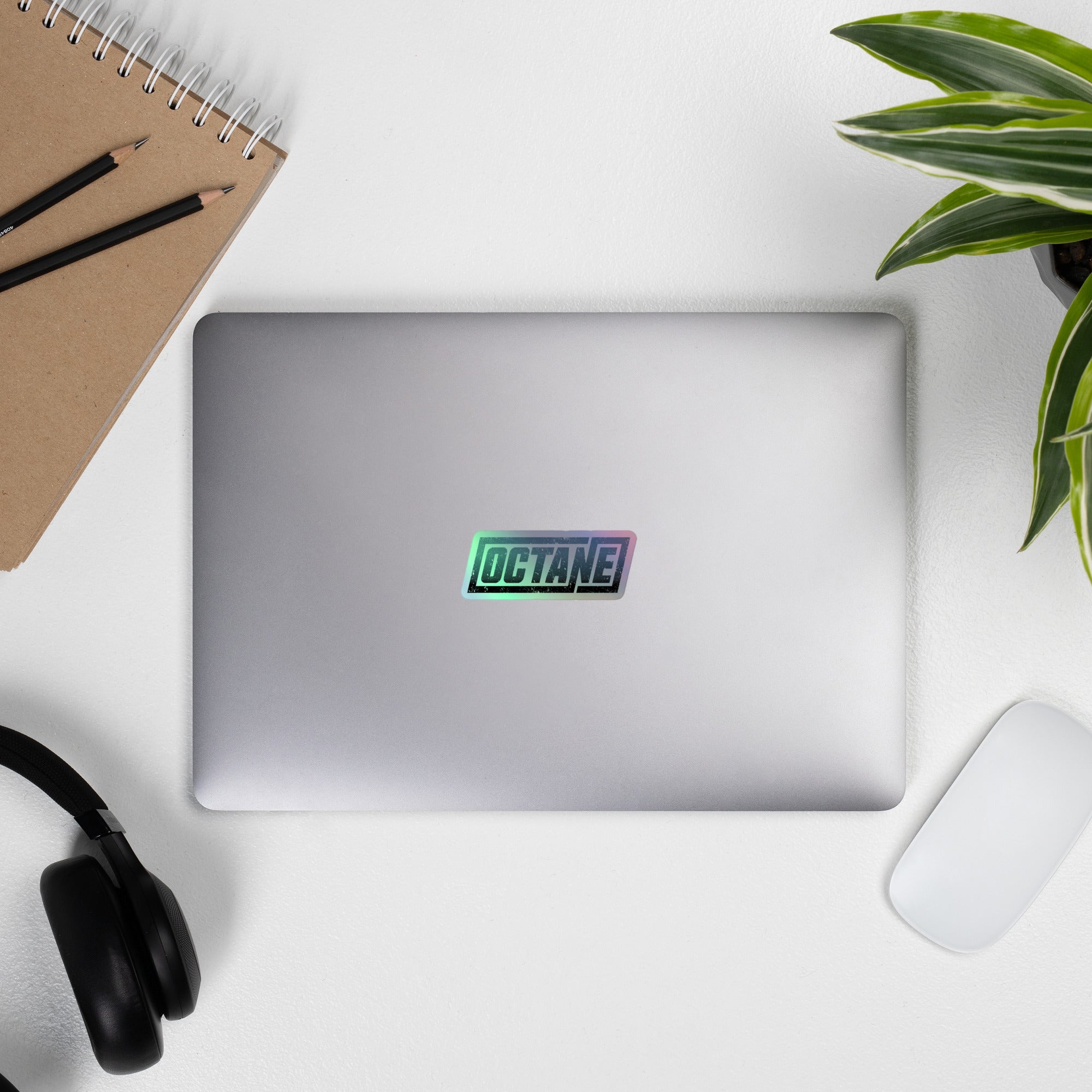 A laptop displaying an 'OCTANE' holographic sticker.