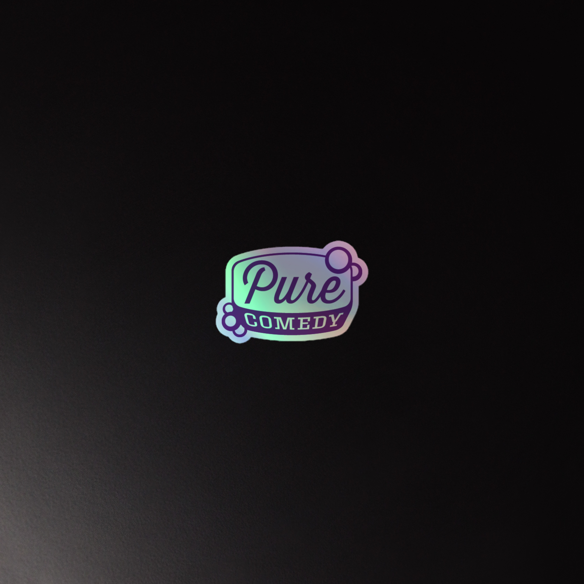 Holographic logo sticker for 'Pure Comedy' with playful purple font on a black background.