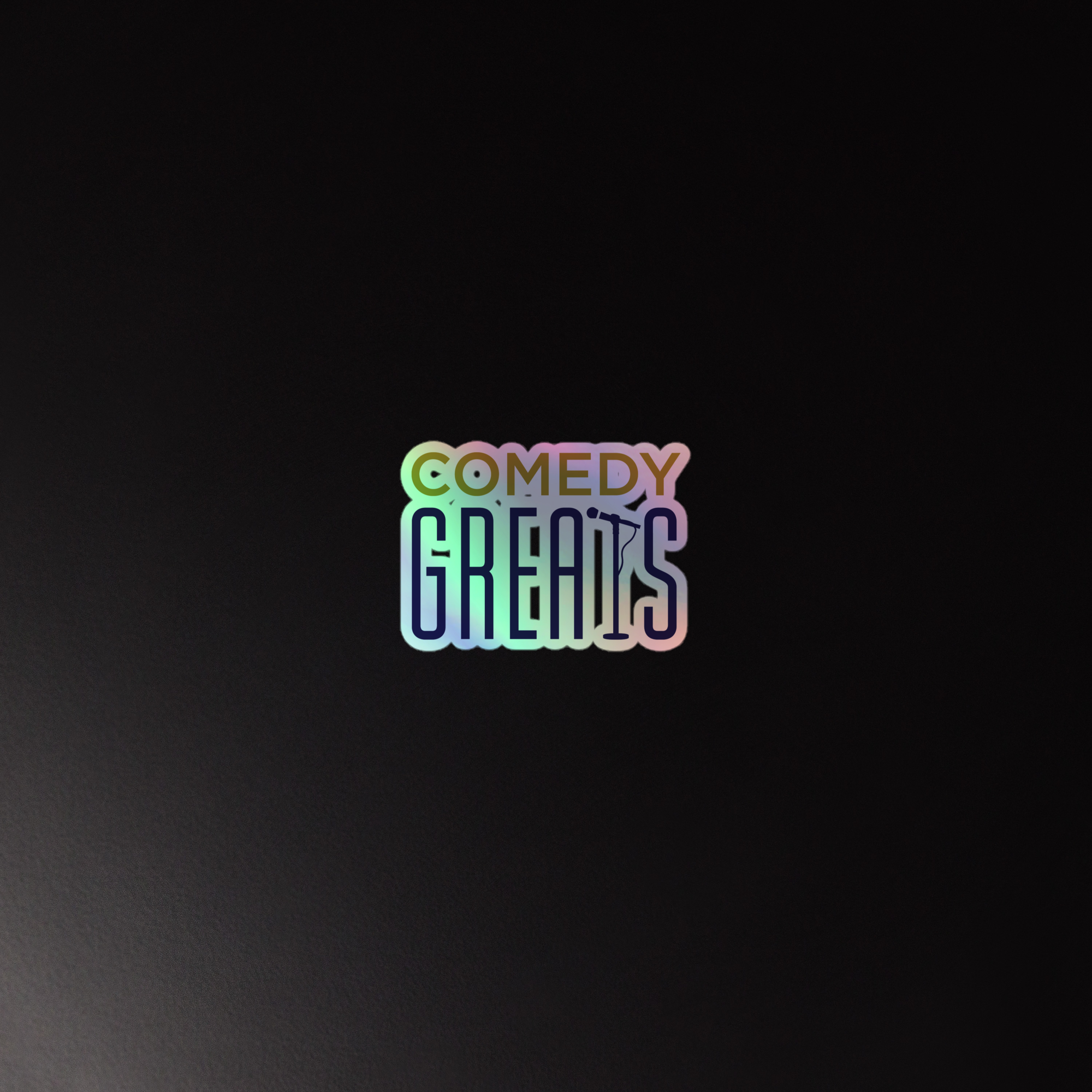 Holographic sticker of the 'COMEDY GREATS' logo in colorful, stylized text on a dark background.
