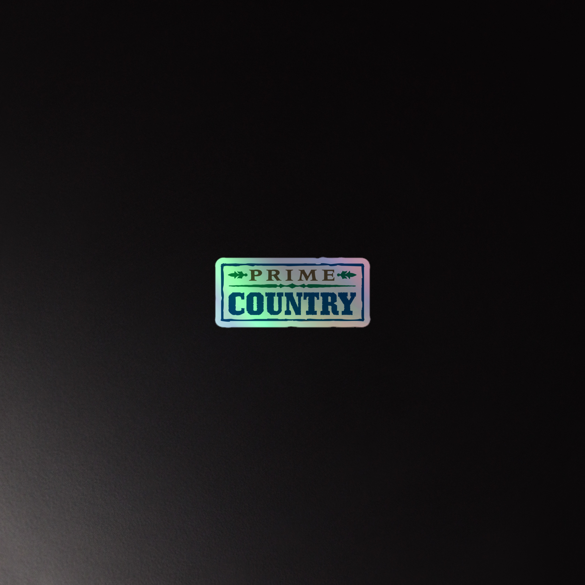 Holographic sticker displaying the text 'PRIME COUNTRY' on a dark background.