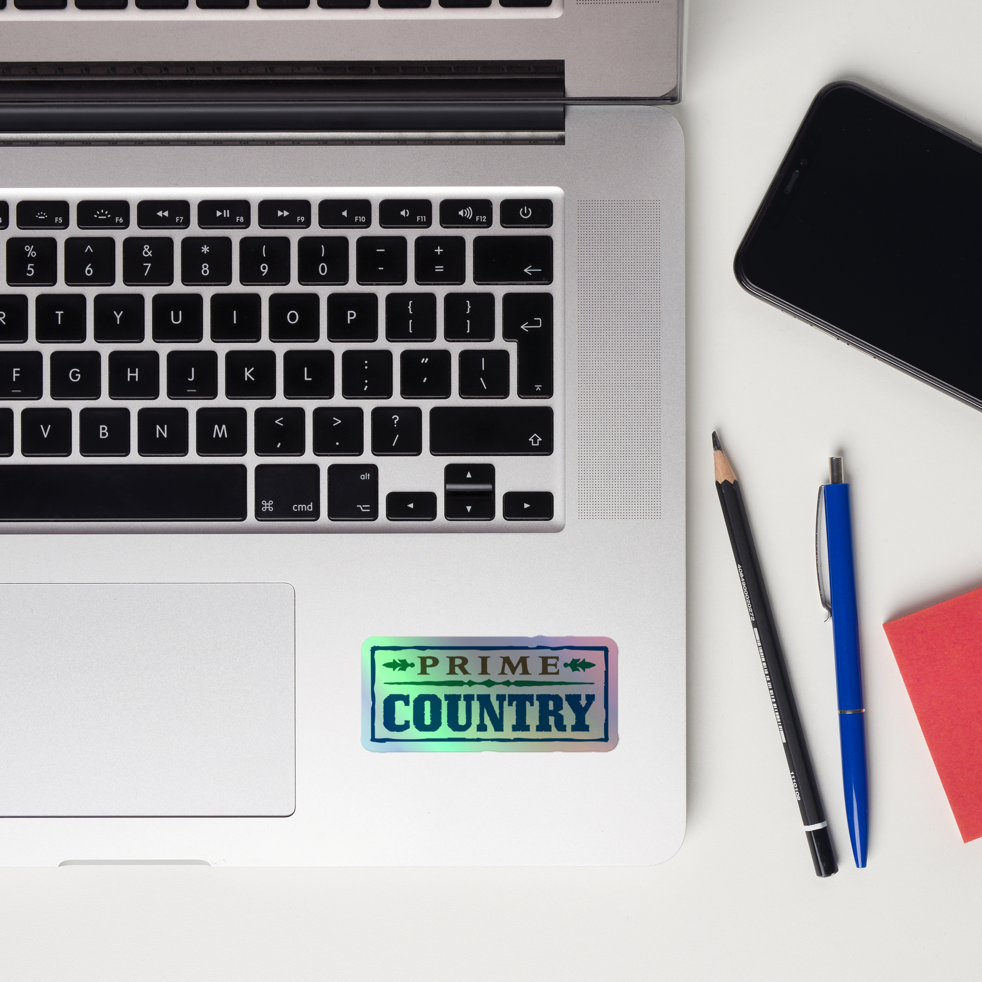 A laptop keyboard displaying a 'PRIME COUNTRY' holographic sticker.