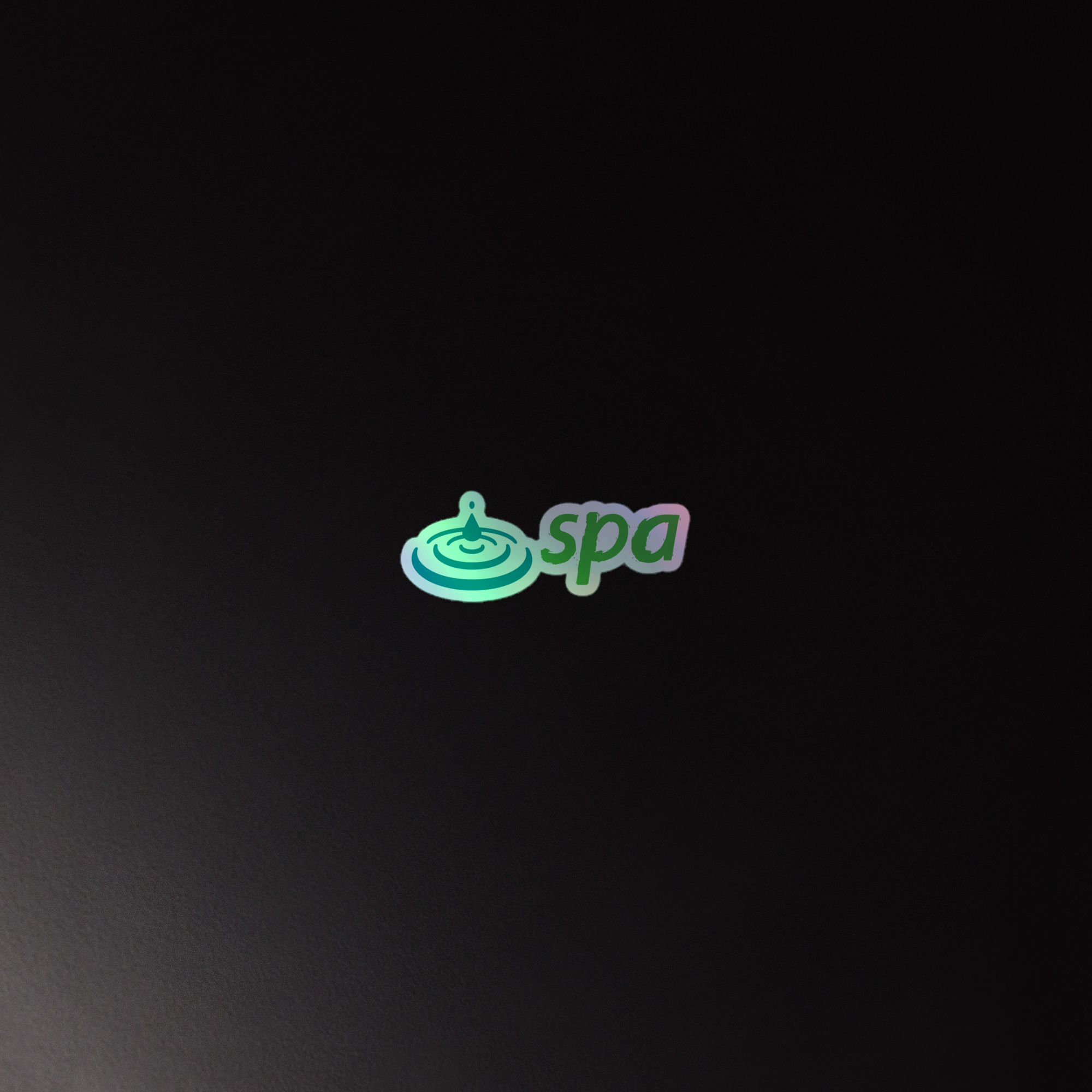 Holographic sticker featuring the word 'spa' and a water droplet design, set against a dark background.