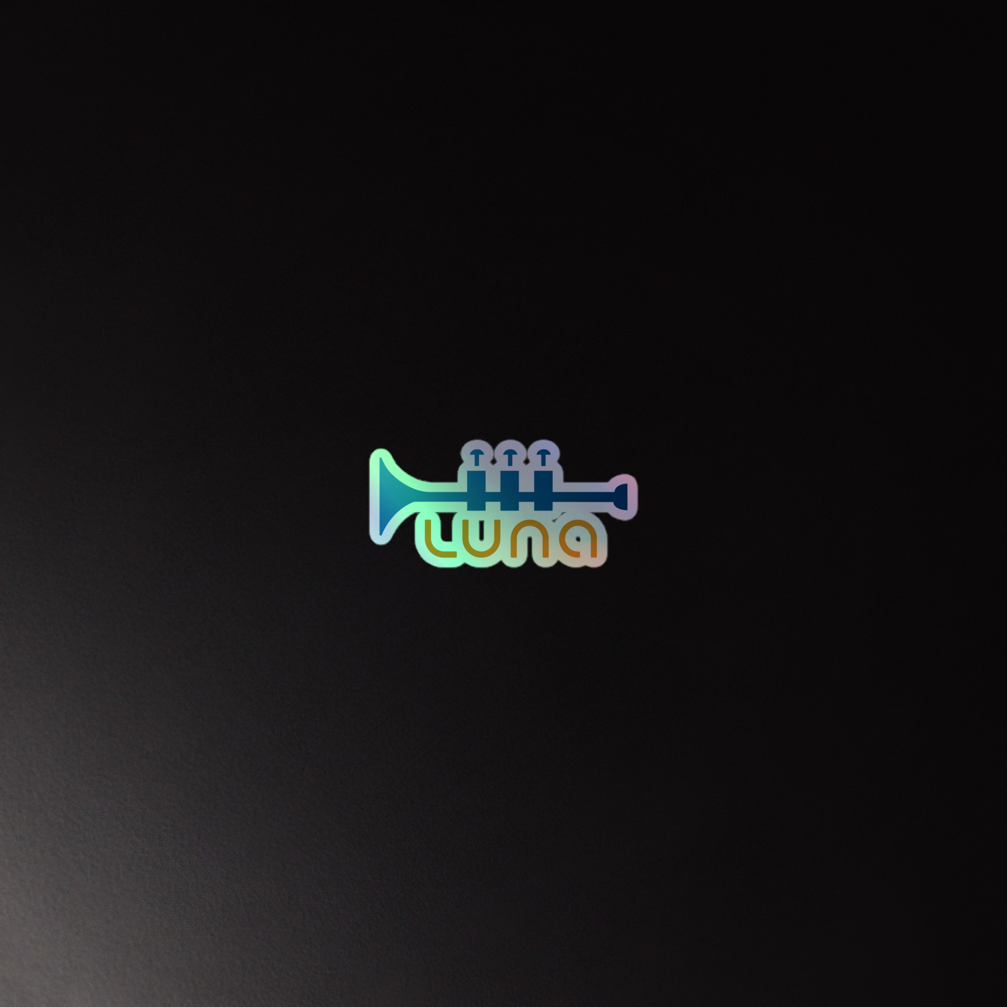 Holographic sticker of a trumpet and 'luna' logo in a colorful, playful font against a dark background.