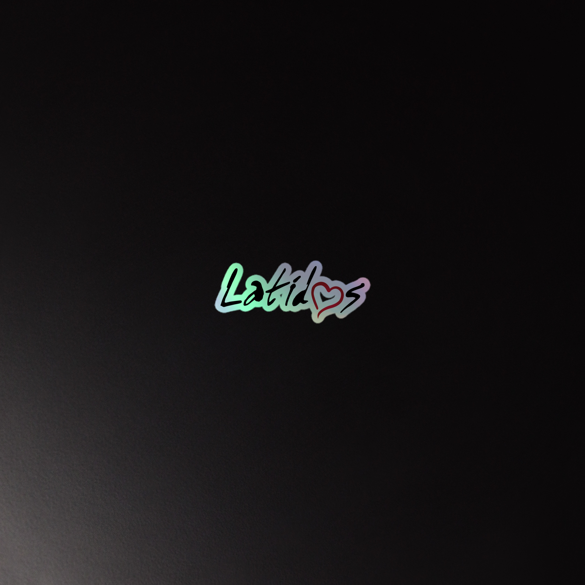 Colorful holographic sticker of the 'Latido' logo on a dark background.