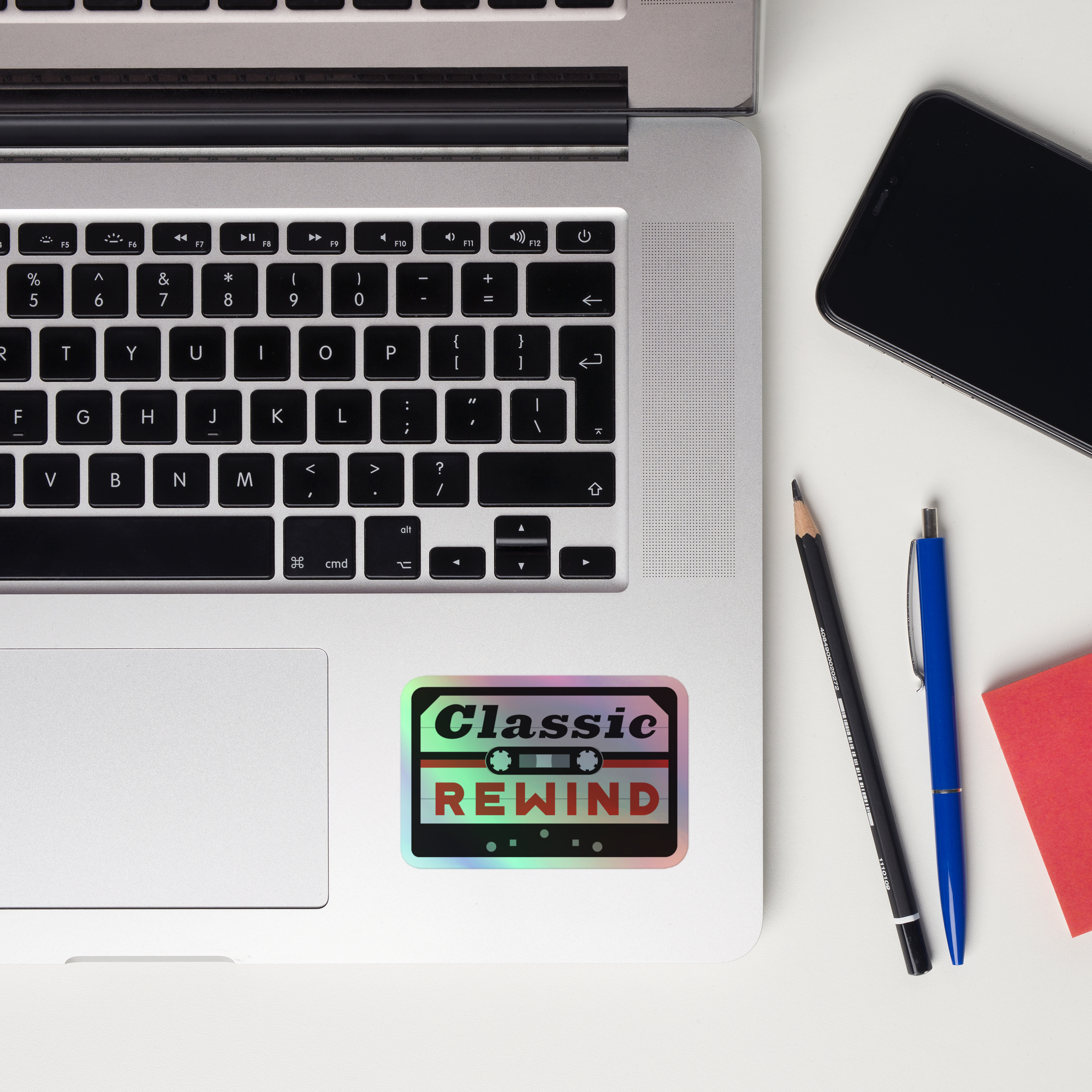 A laptop keyboard displaying a 'Classic Rewind' holographic sticker.