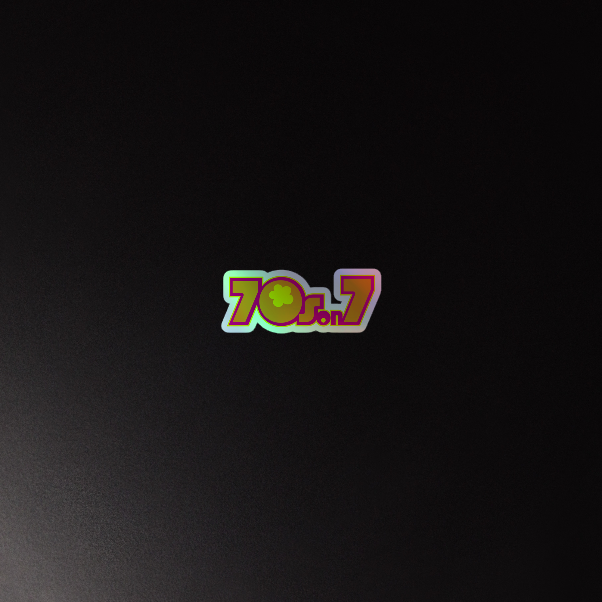 Colorful holographic sticker of the '70s on 7' logo against a dark background.