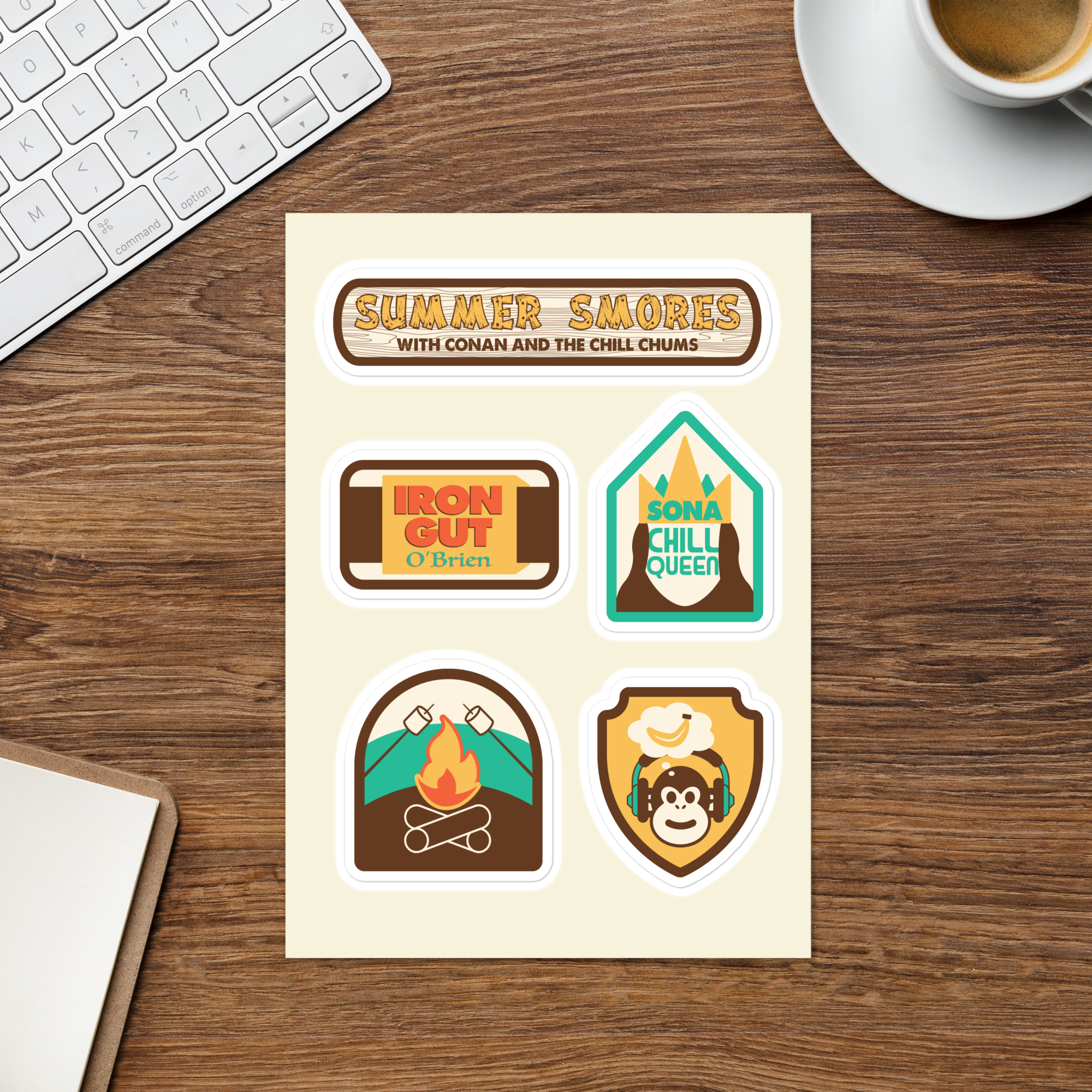 Colorful sticker sheet featuring 5 different stick designs including 'Summer Smores' 'Iron Gut O'Brien' 'Sona Chill Queen,' and a campfire design on a wooden desk background.