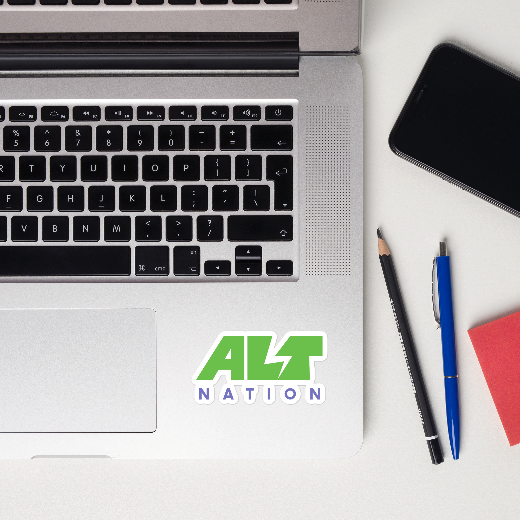 Top down view of a laptop keyboard displaying an 'ALT NATION' sticker.
