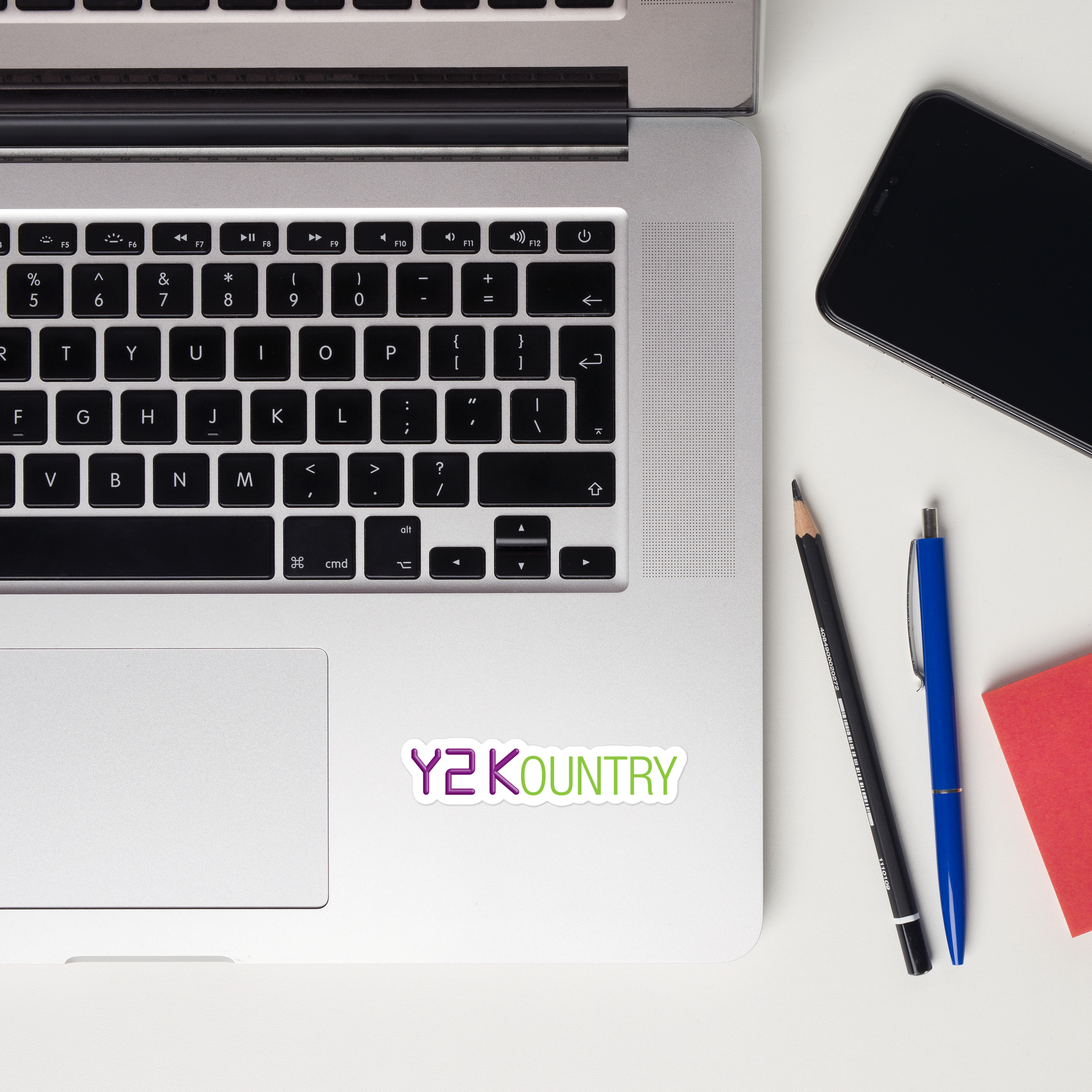 A laptop keyboard displaying a 'Y2Kountry' logo sticker.