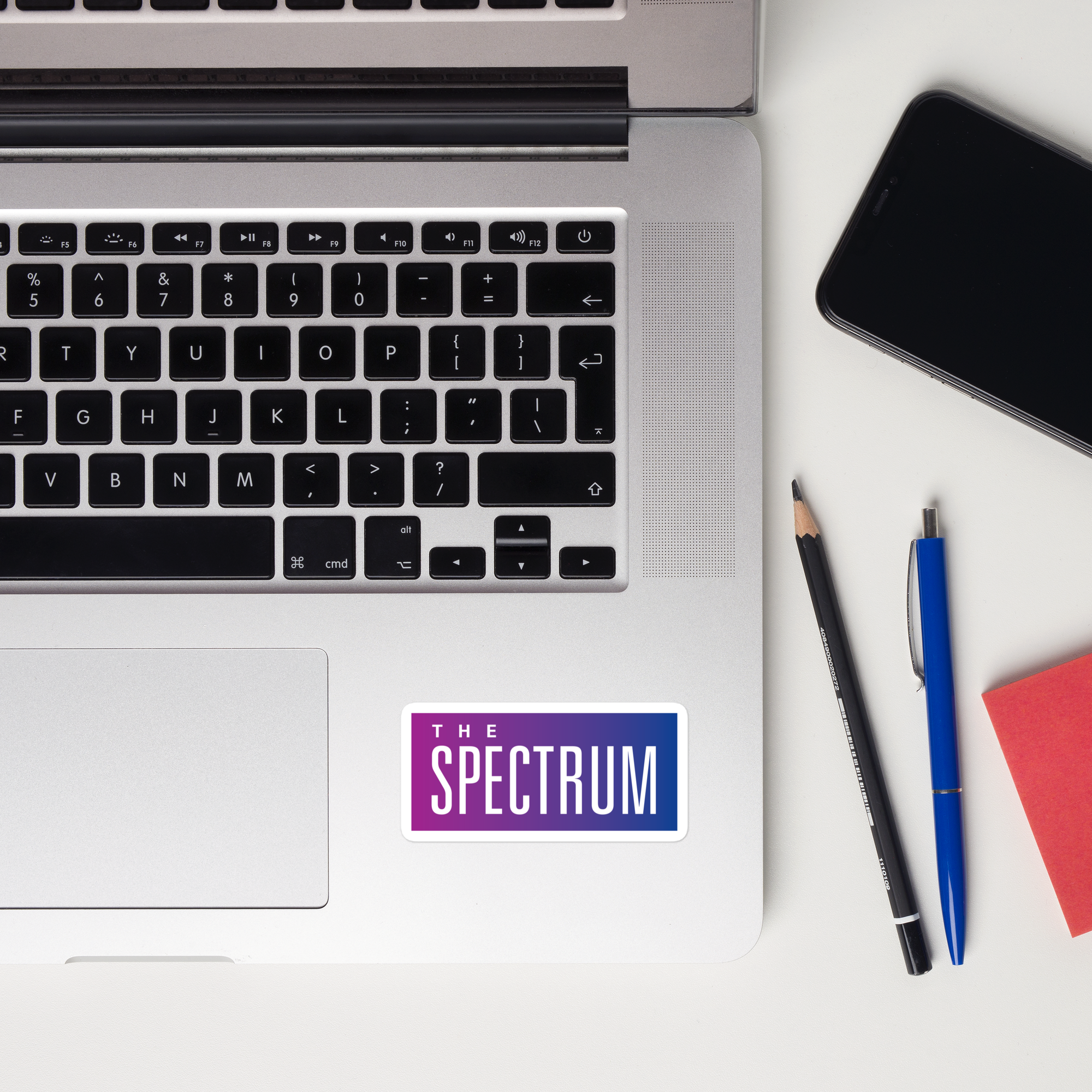 Laptop keyboard displaying a 'The Spectrum' sticker.