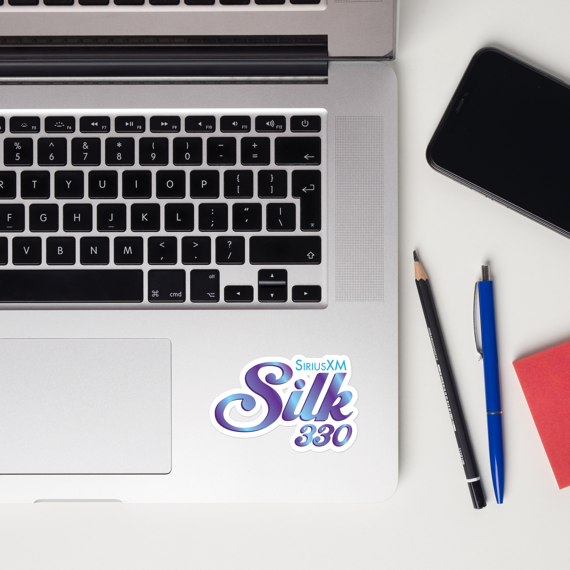 A laptop keyboard displaying a 'SiriusXM Silk 330' sticker.