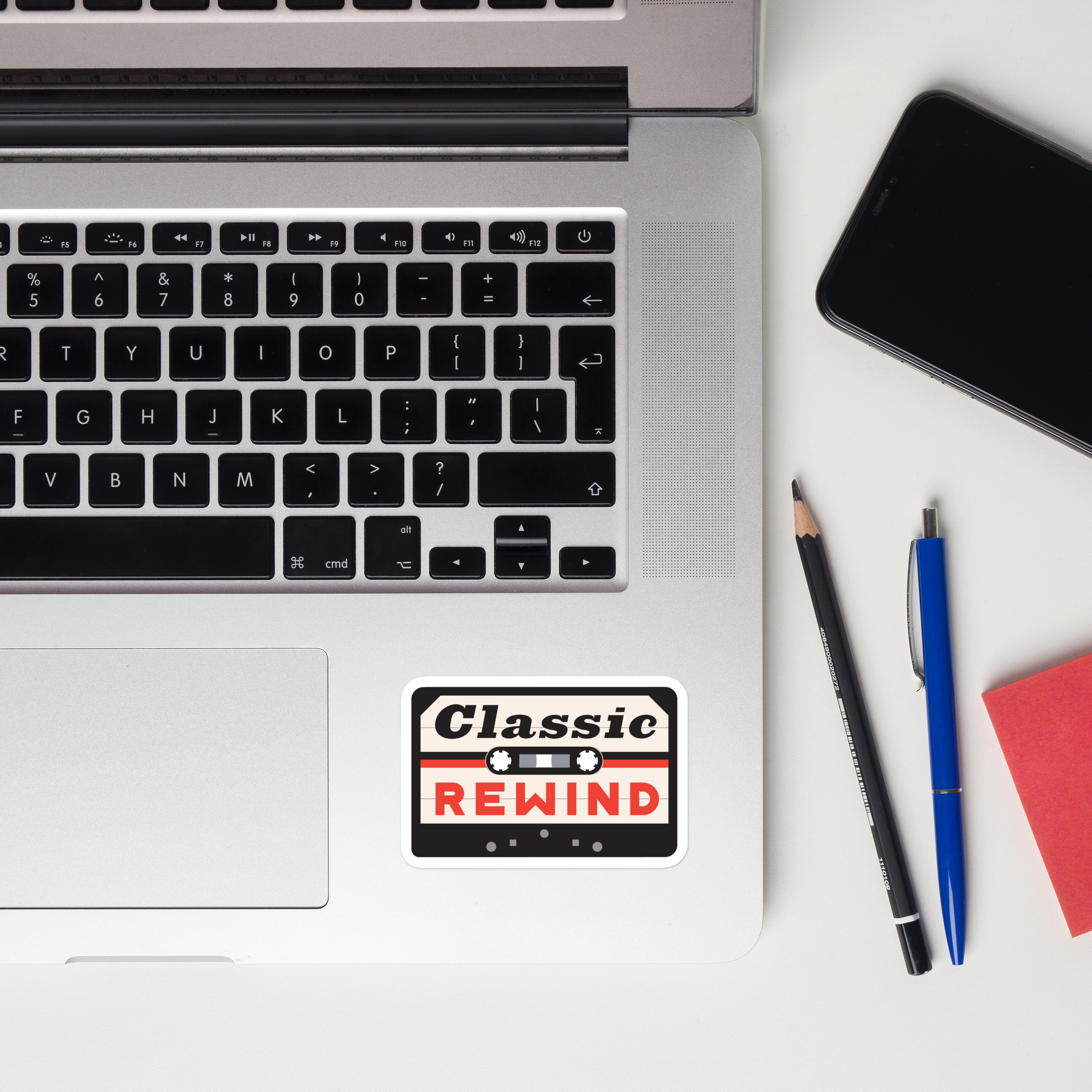 Laptop keyboard displaying a 'Classic Rewind' cassette tape sticker.