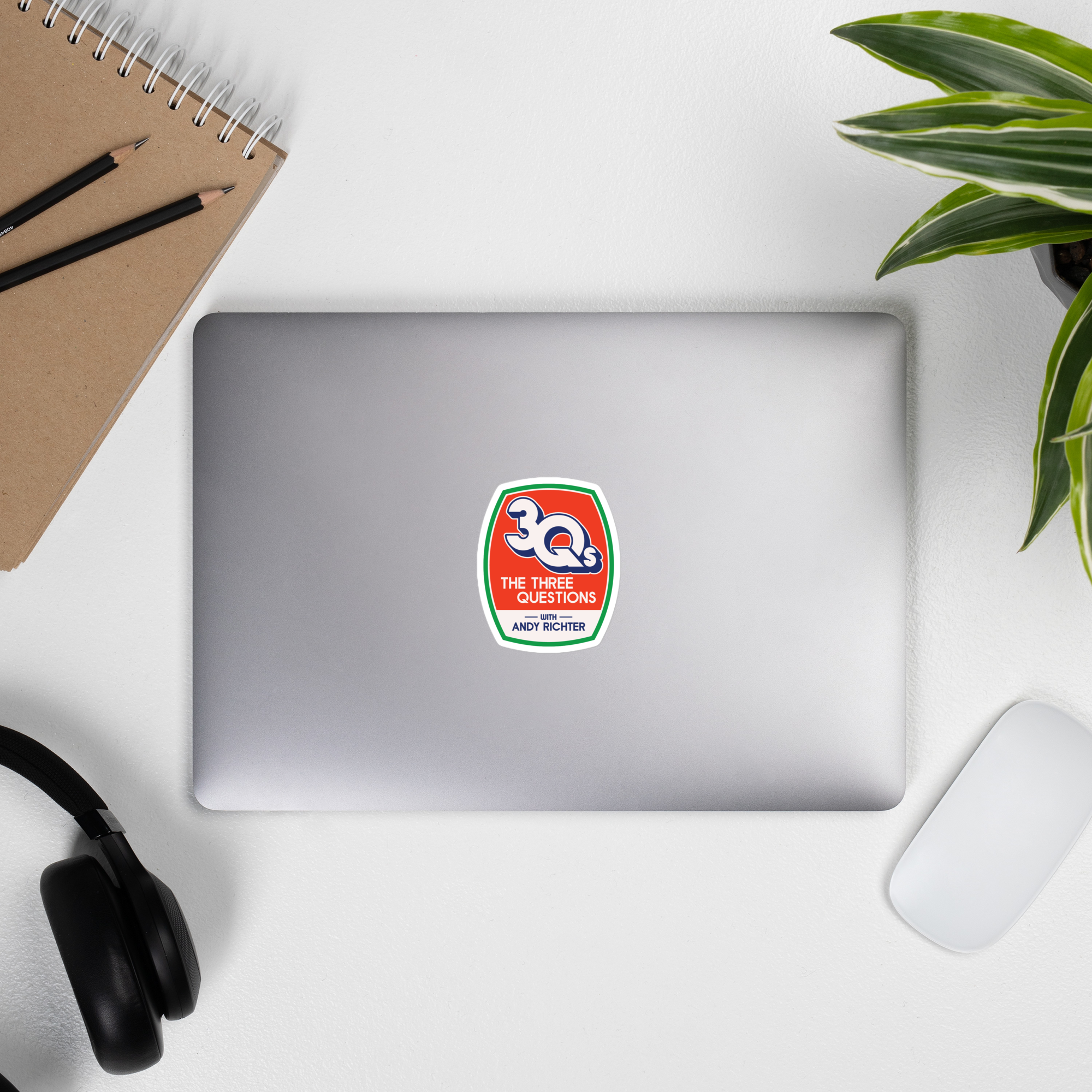 Laptop displaying a '30Qs THE THREE QUESTIONS ANDY RICHTER' sticker on it.