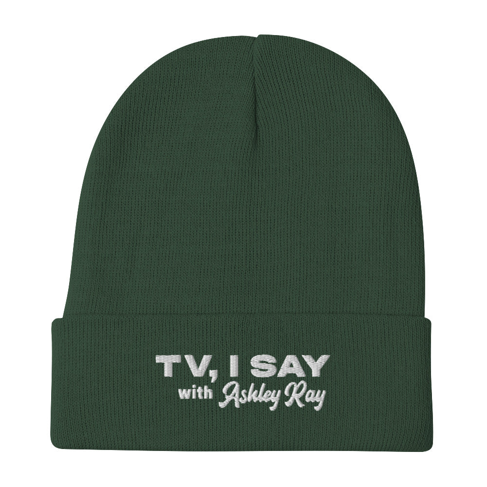 Green beanie with embroidered text: 'TV, I SAY with Ashley Ray.'