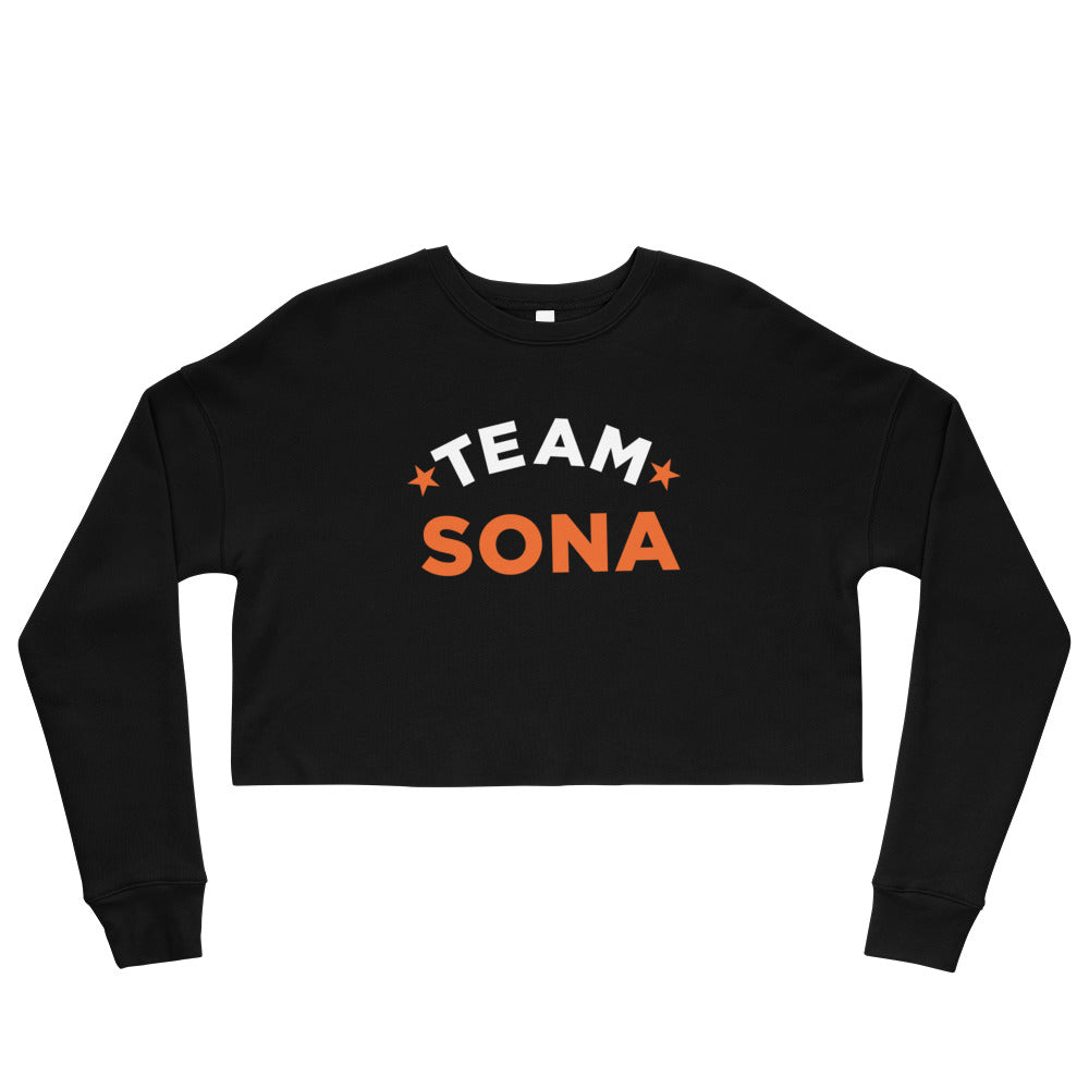 Black cropped sweatshirt with 'TEAM SONA' printed in bold white and orange letters on a white background.