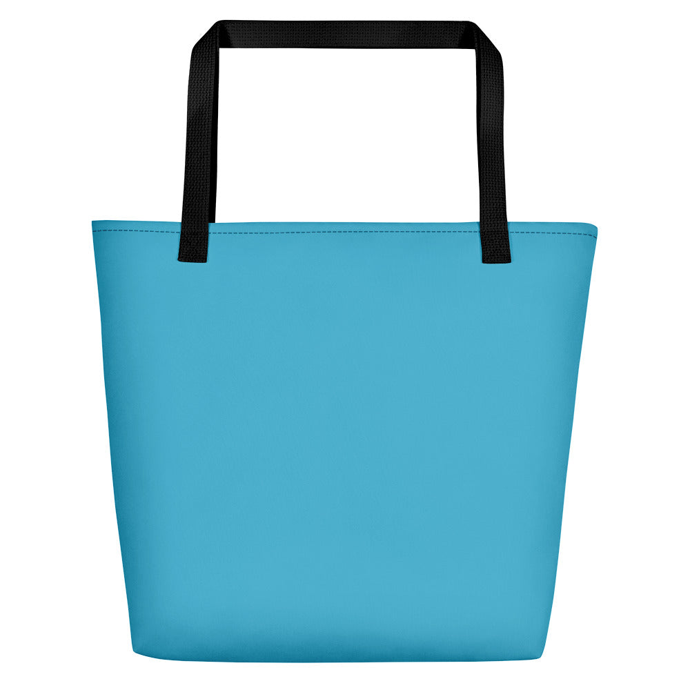 Back side of teal beach bag with black handles.