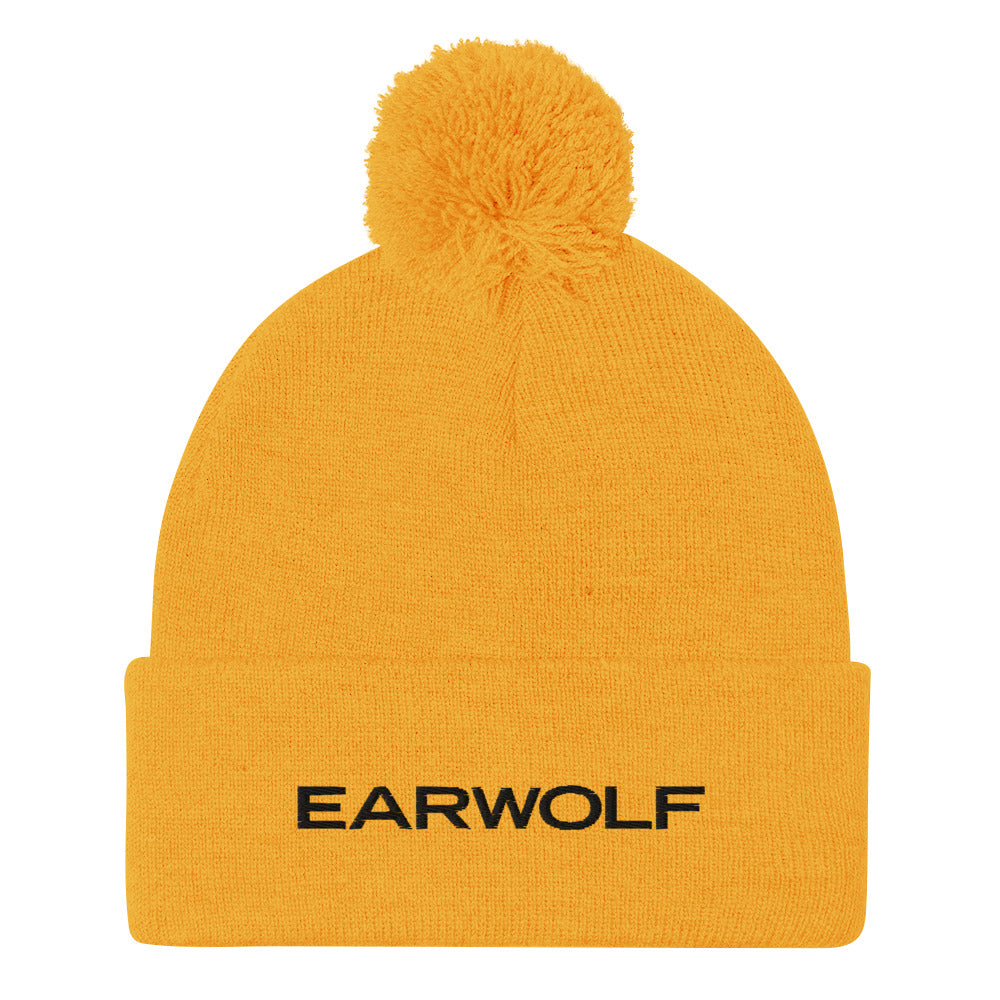 Yellow knitted beanie hat with a pom-pom on top and 'EARWOLF' printed in black text.