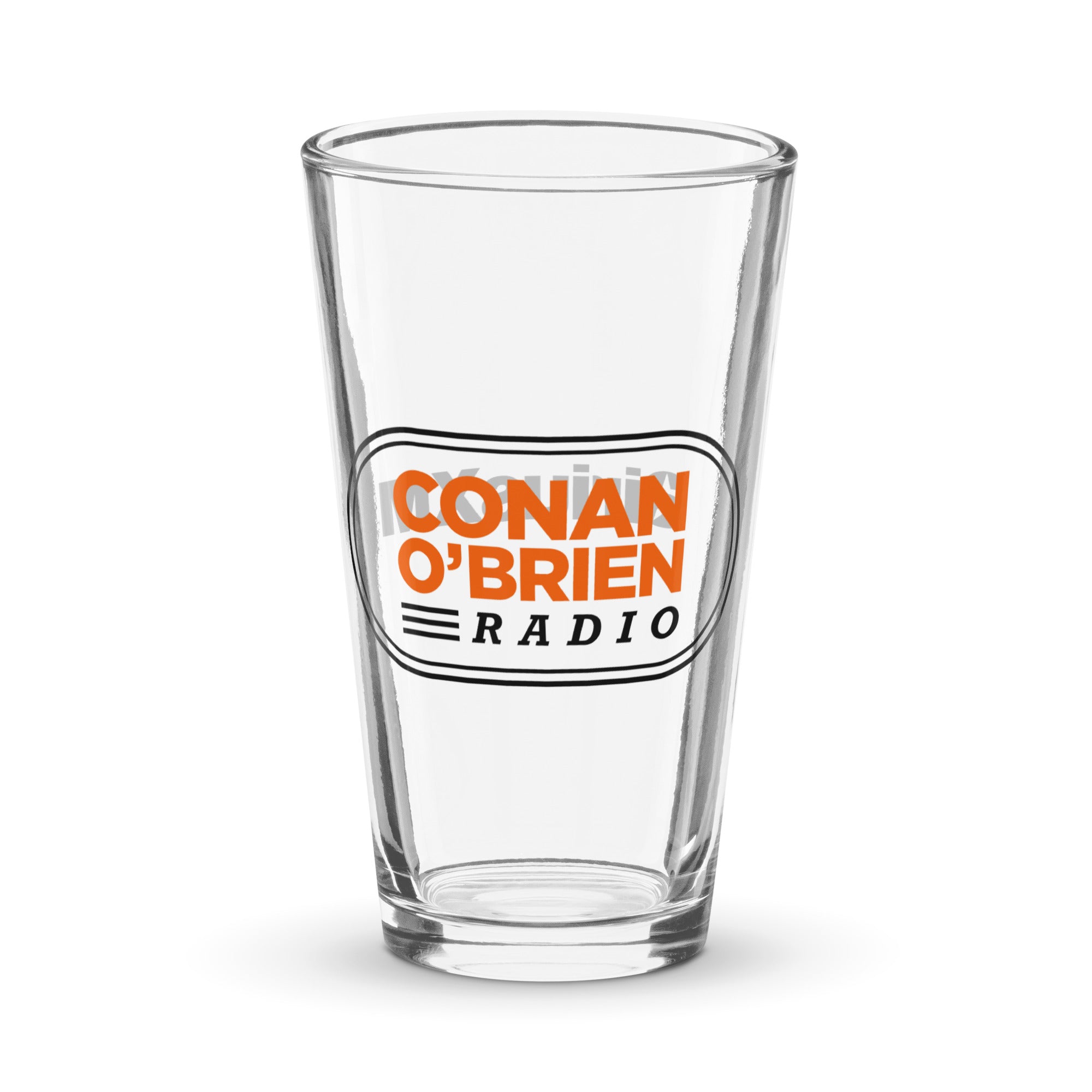 A clear pint glass pint featuring the text 'CONAN O'BRIEN RADIO' in orange and black.