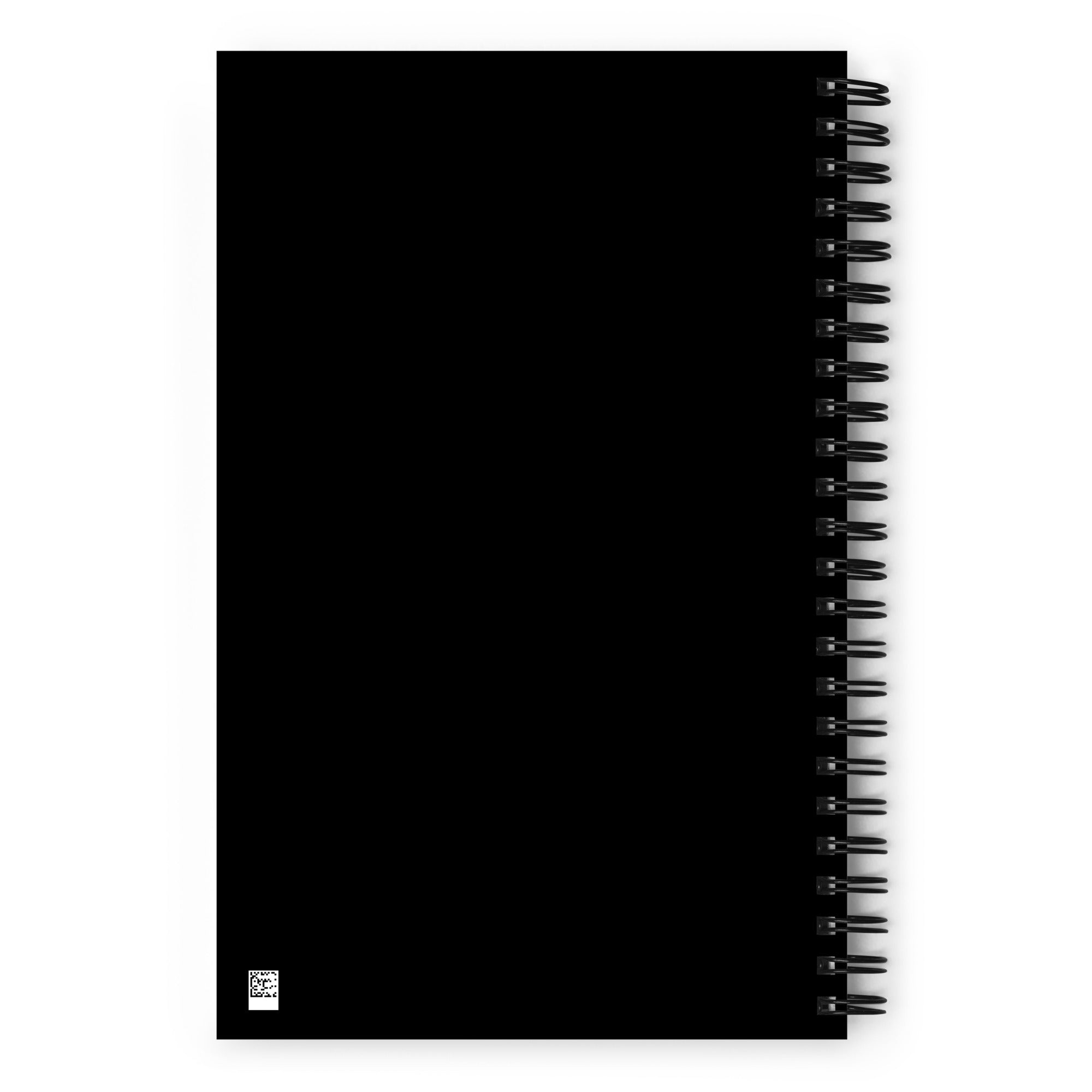 Flat view of the solid black back cover of the spiral notebook. A small QR code is visible in the bottom left corner.