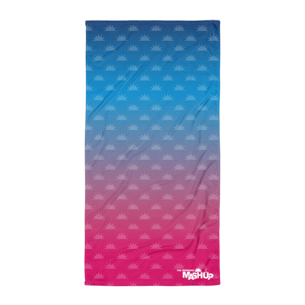 Blue to pink gradient beach towel with a crown pattern and 'THE MORNING MASHUP' logo.