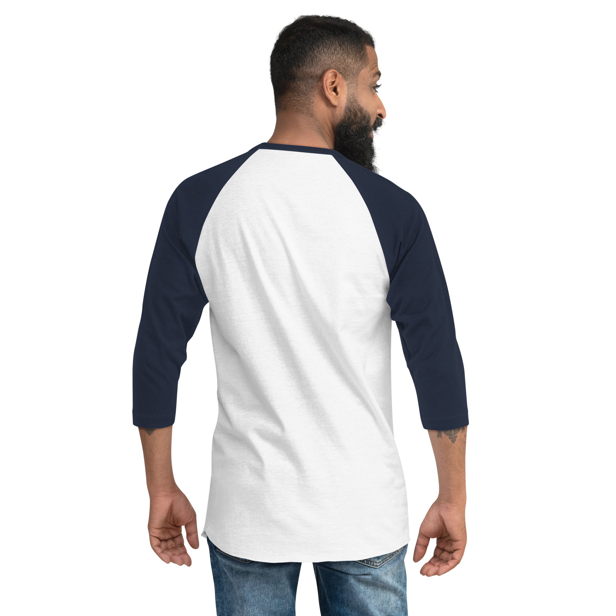 Back view of a white and navy raglan sleeve shirt – A man stands facing away from the camera wearing a white raglan shirt with navy blue three-quarter sleeves and collar. The back of the shirt is blank.