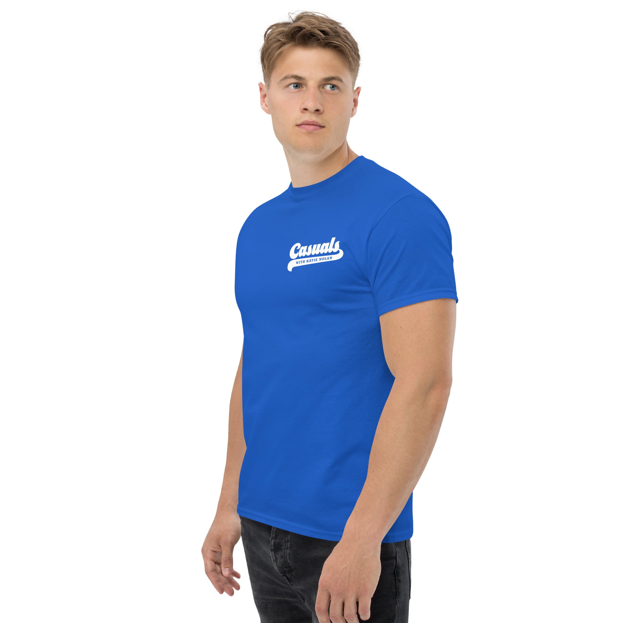 Man wearing a royal blue short-sleeve t-shirt with a small white logo on the left chest reading 'Casuals' and 'WITH KATIE NOLAN' underneath.