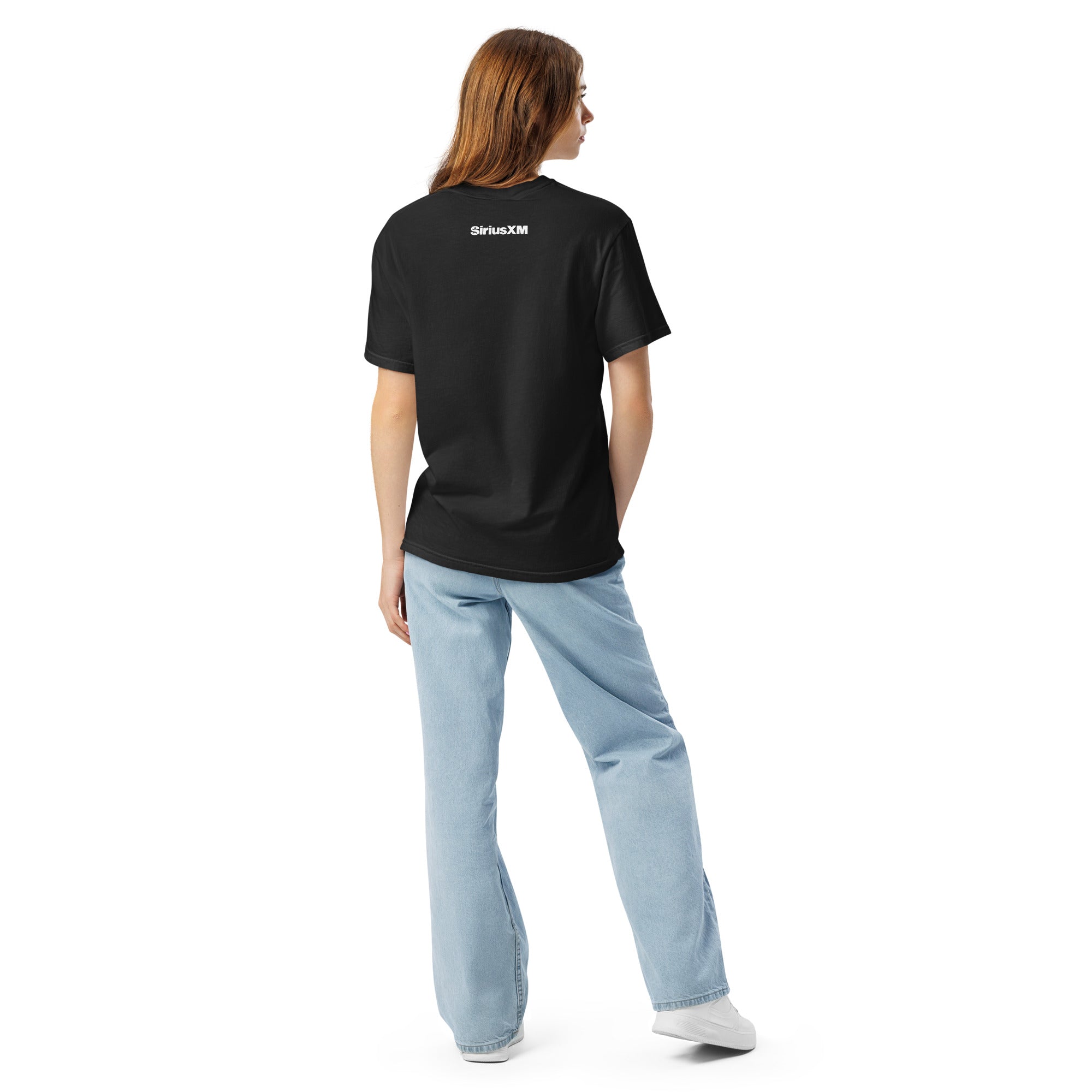 Back view of a black unisex heavyweight T-shirt worn by a woman, featuring a small white 'SiriusXM' logo printed across the upper back.
