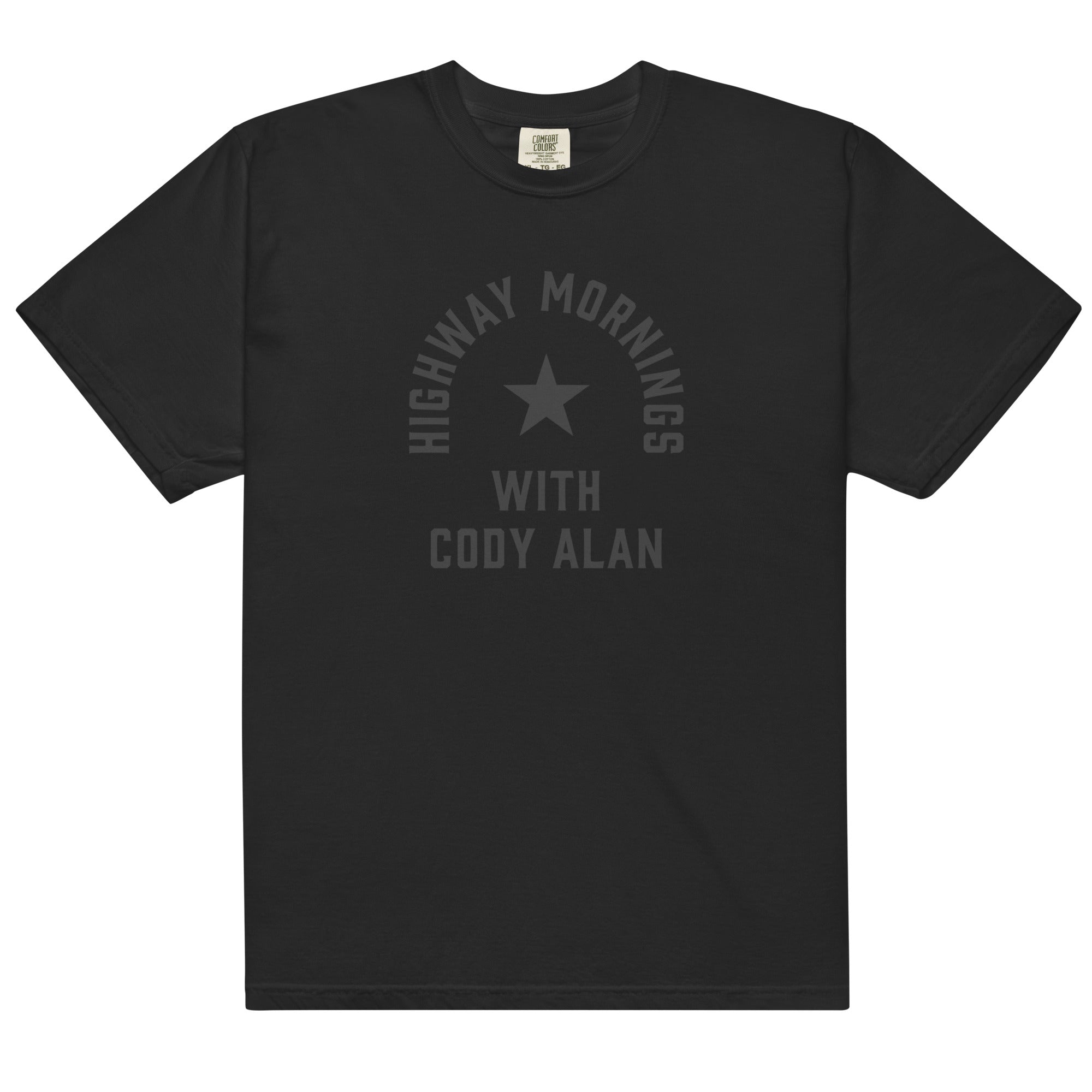 Flat lay front view of a black short-sleeve T-shirt. The shirt’s front displays a black-on-black design with a star in the center and the text 'HIGHWAY MORNINGS WITH CODY ALAN' printed in black across the chest.