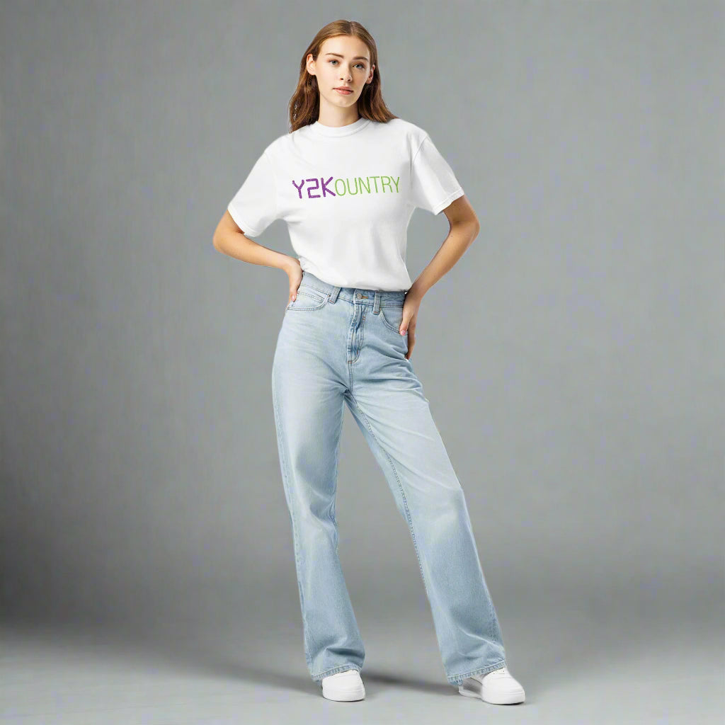 Front view of a white T-shirt worn by a woman, featuring 'Y2KOUNTRY' in bold capital letters across the chest, with 'Y2K' in purple and 'OUNTRY' in green.